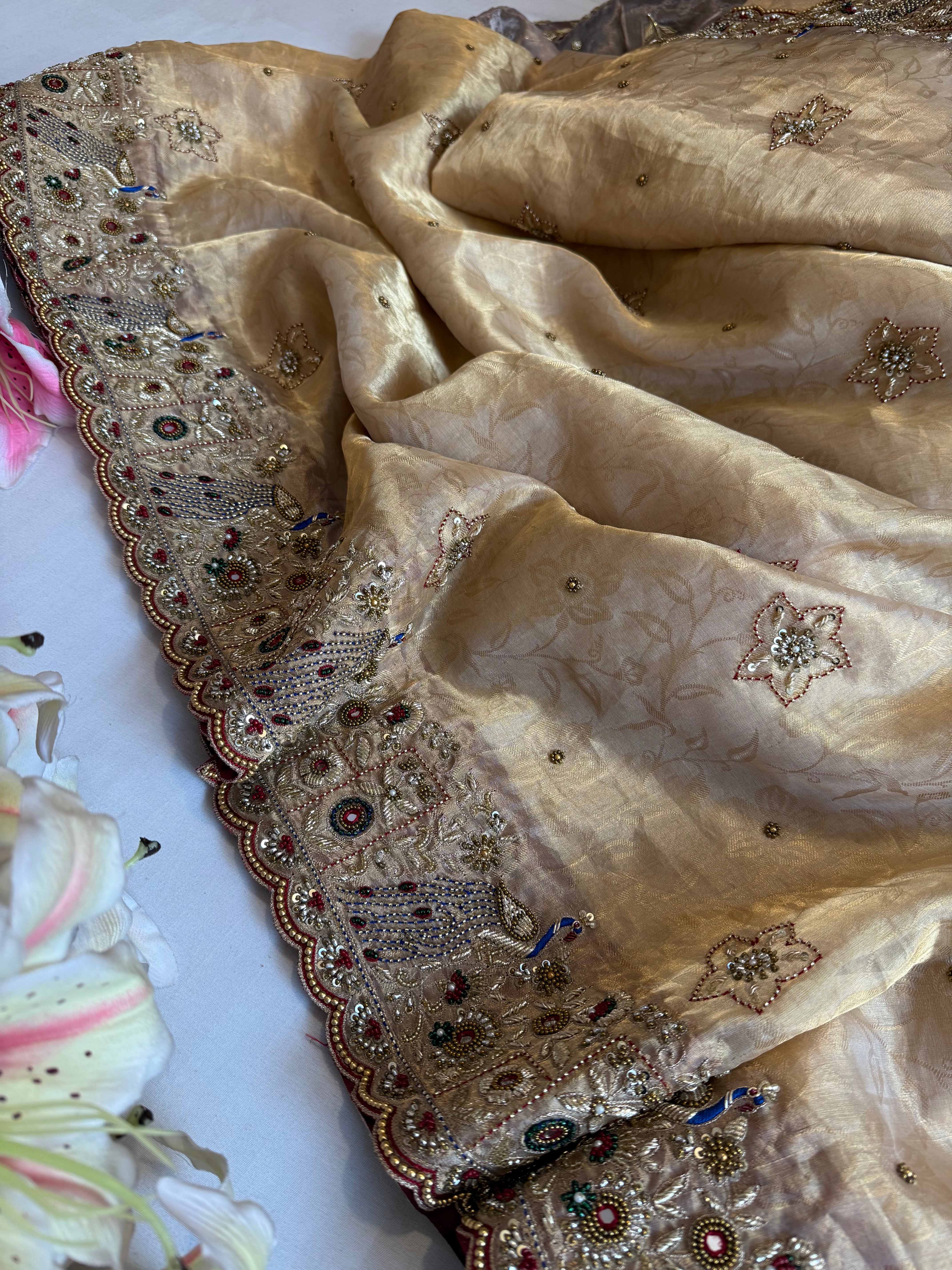 Jadau molten gold tissue silk hand embroidered peacock motif saree