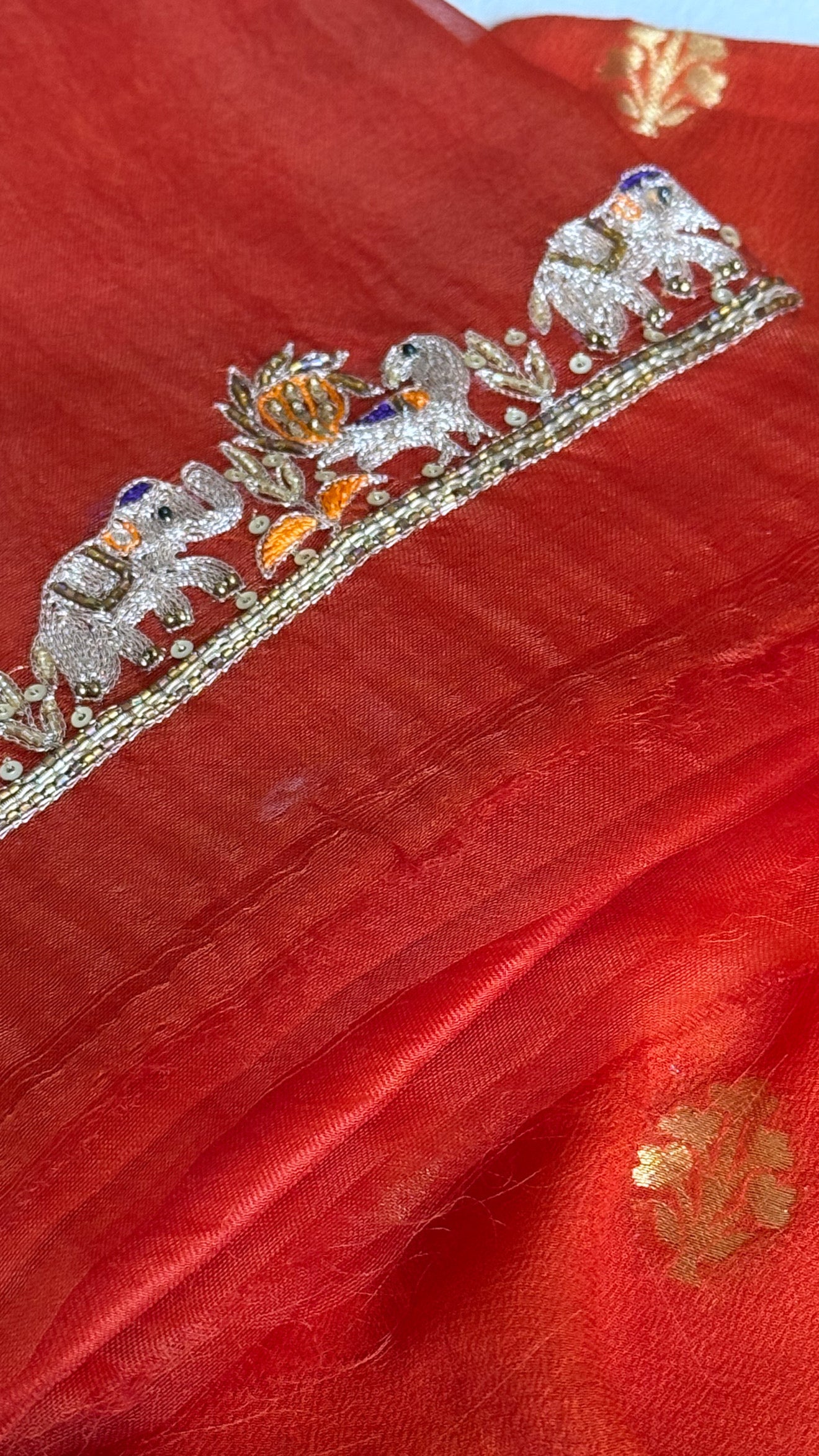 Burnt orange banarasi gorgette kadhwa buti kurta paired with toy hathi motif hand embroidered scalloped kora duppata