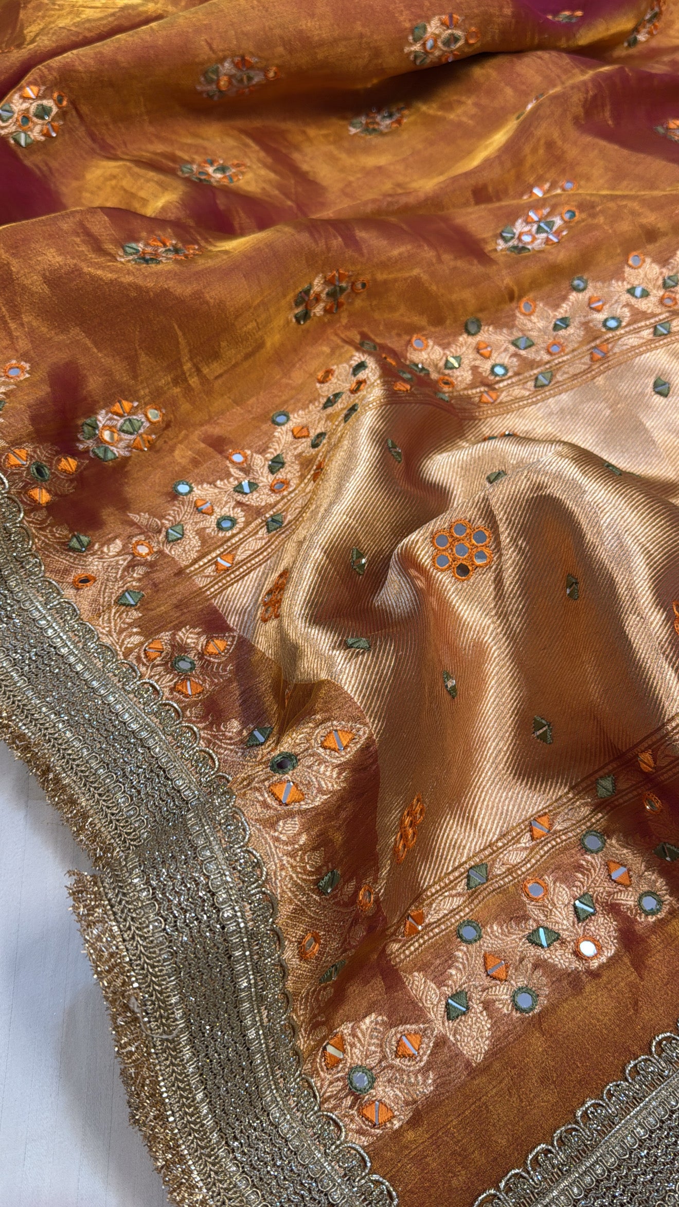 Orangey red mirror work heavy hand embroidered kadhwa buti tissue silk saree