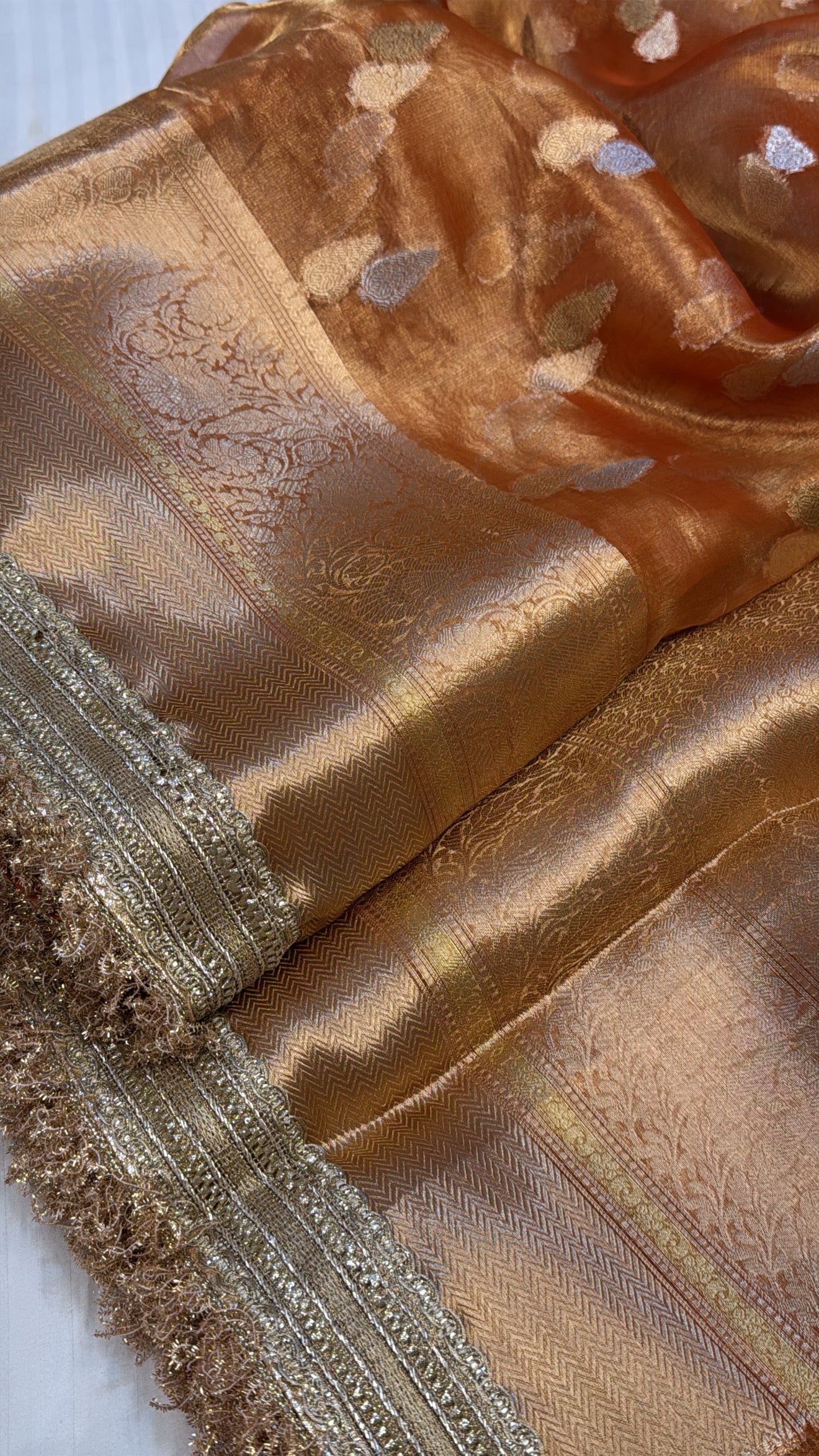 Orangey gold dhup chao effect maharani tissue silk kadhwa buti saree