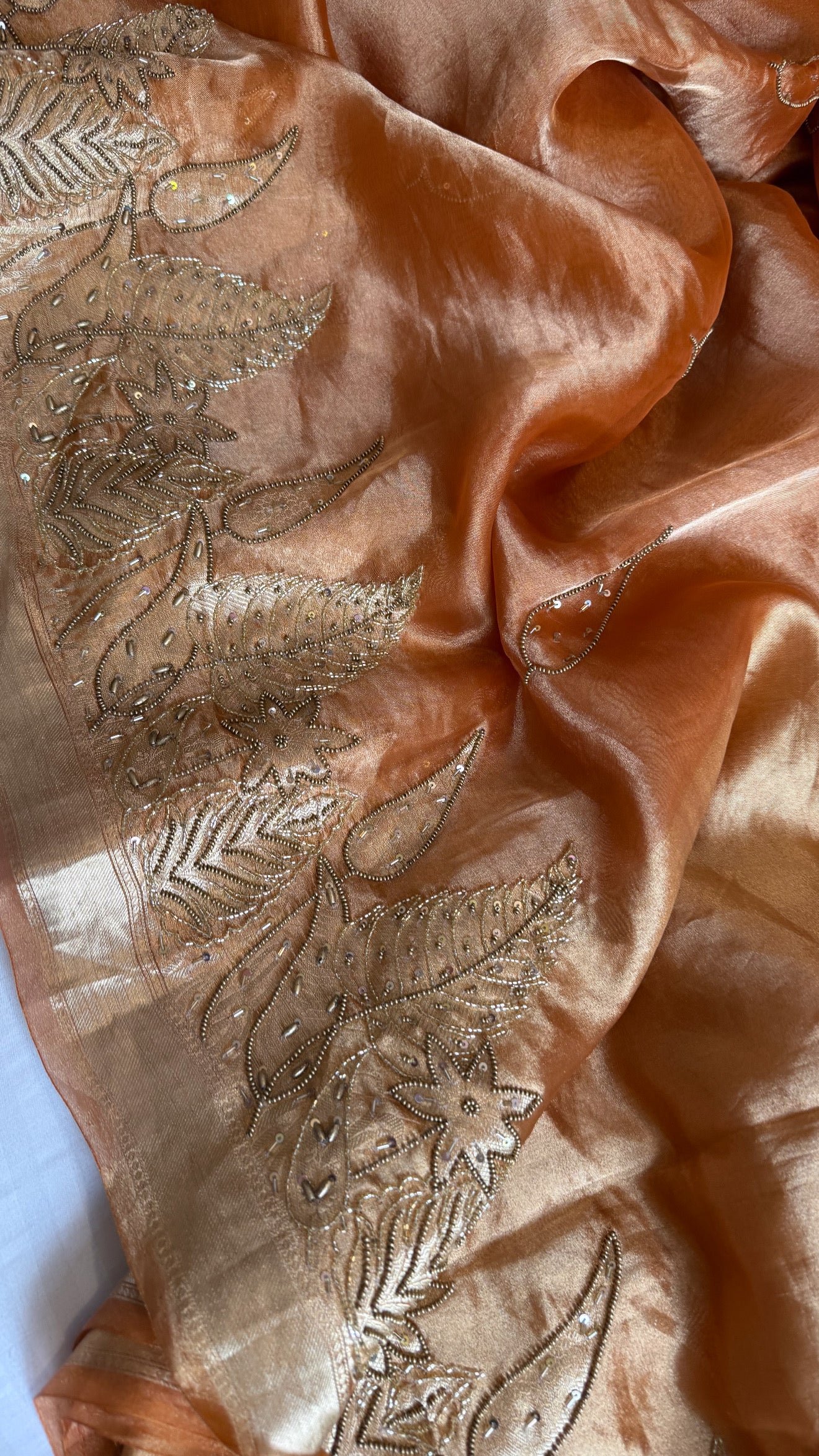 Husn tangerine red tissue silk heavy hand embroidered saree