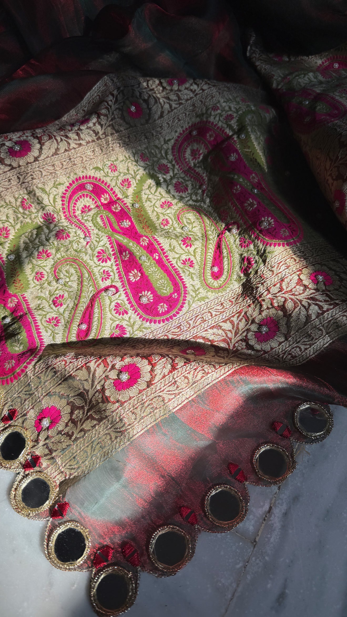 Teej special- Mirror work border maroonish red dhup chao effect tissue silk hand embroidered saree