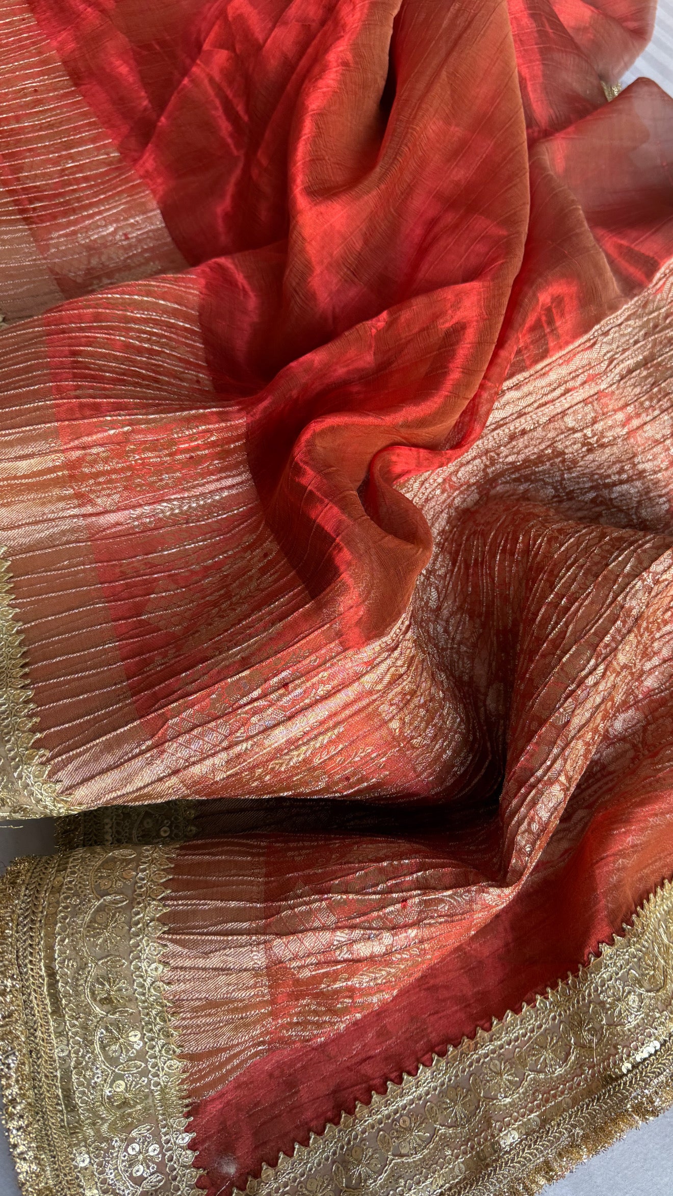 Metallic deep orange dhup chao effect pleated maharani tissue saree