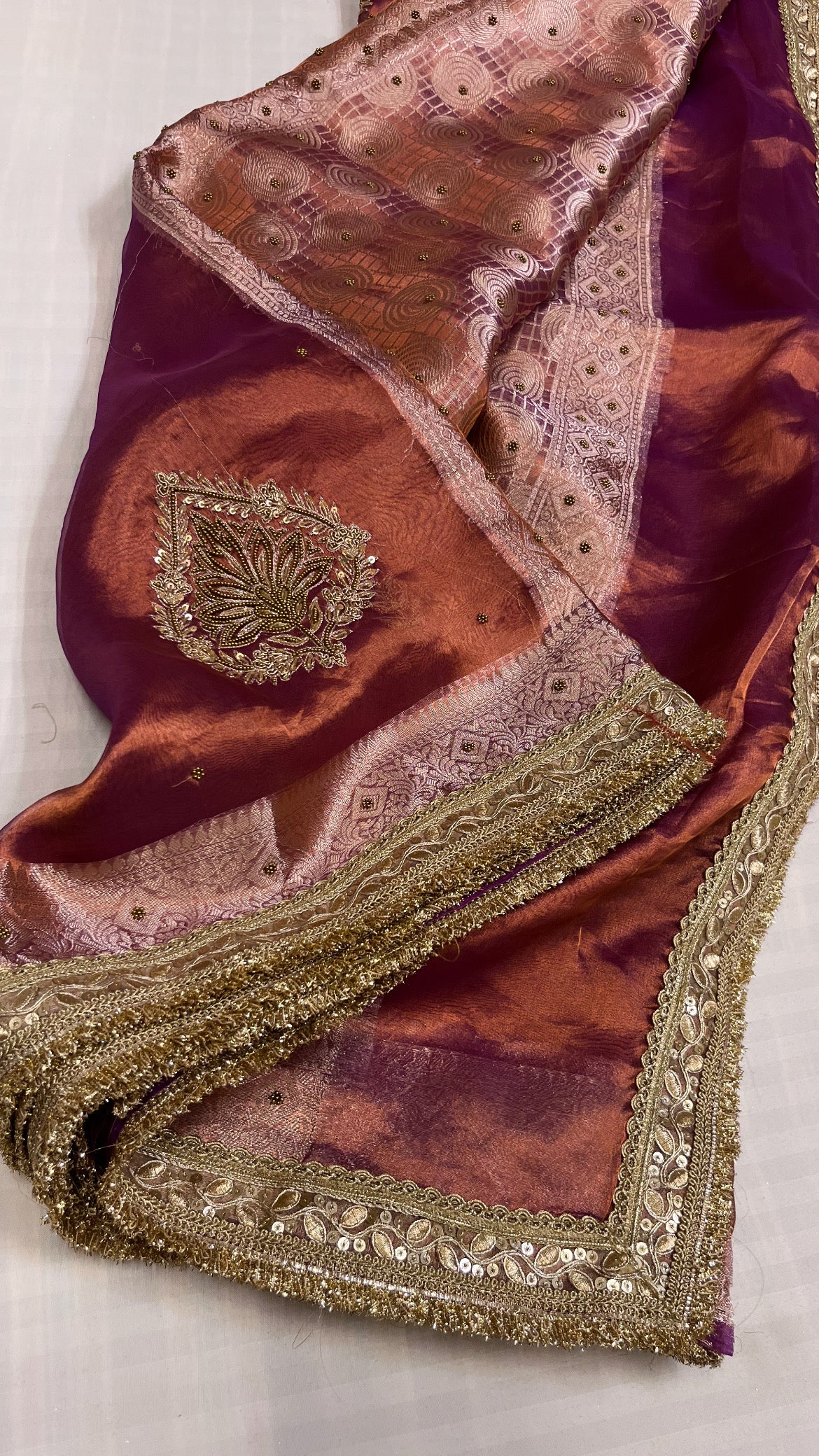 Husn copperish purple tissue silk hand embroidered saree