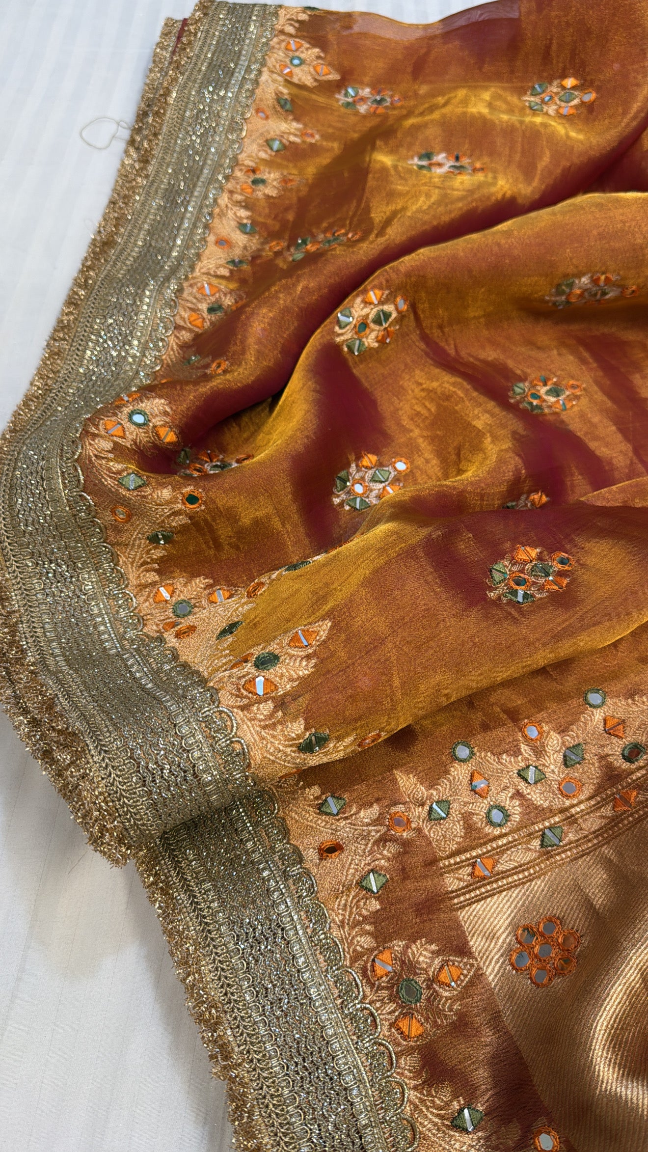 Orangey red mirror work heavy hand embroidered kadhwa buti tissue silk saree