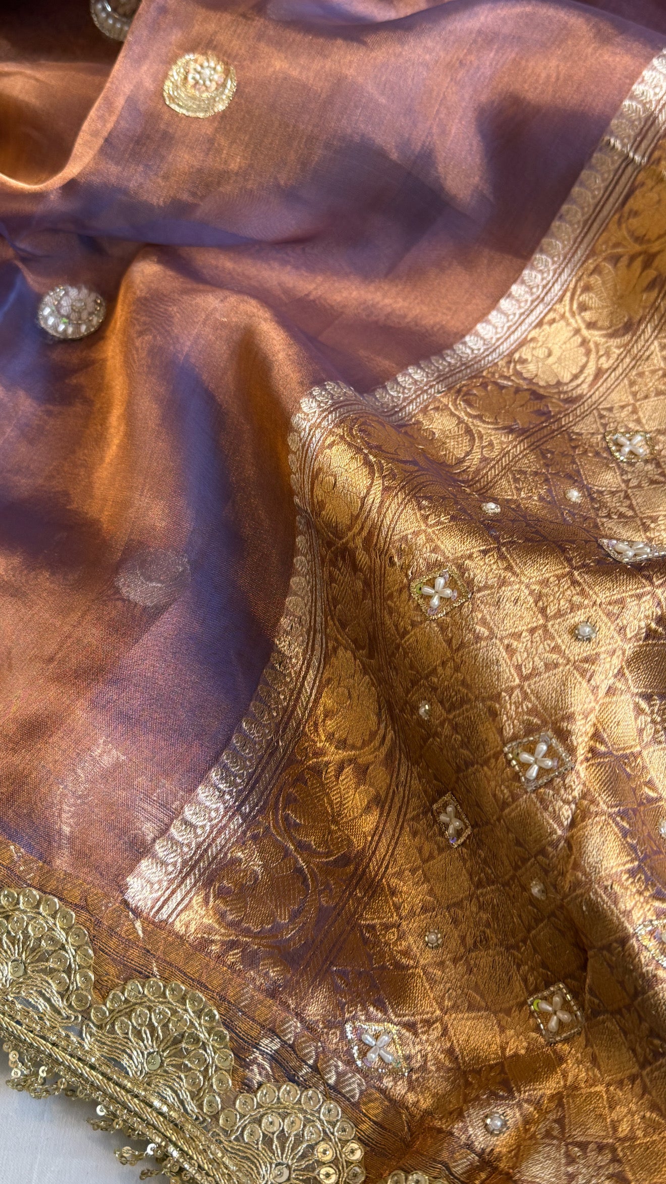 Chand tara copperish blue dhup chao effect tissue silk hand embroidered saree