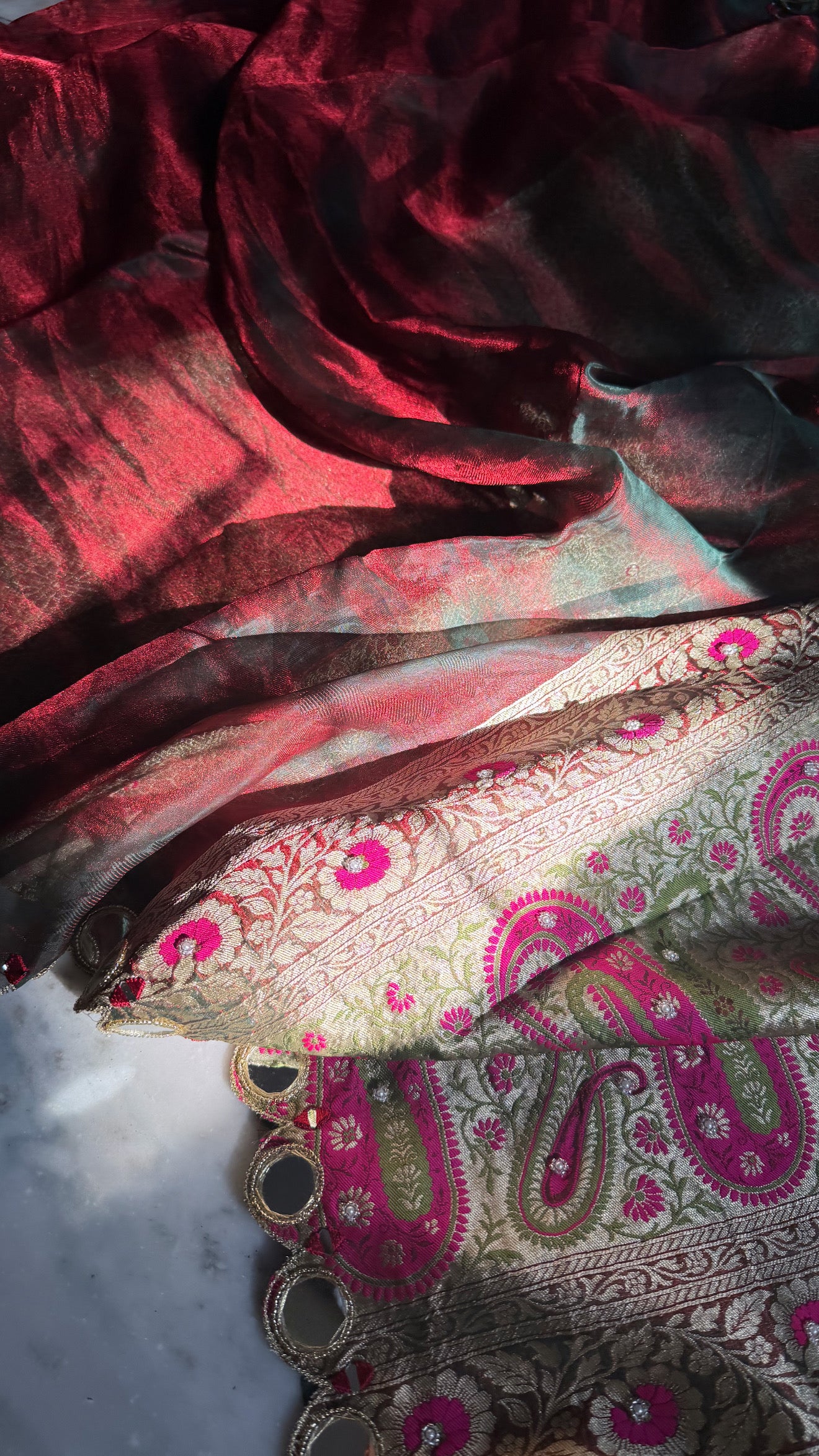 Teej special- Mirror work border maroonish red dhup chao effect tissue silk hand embroidered saree