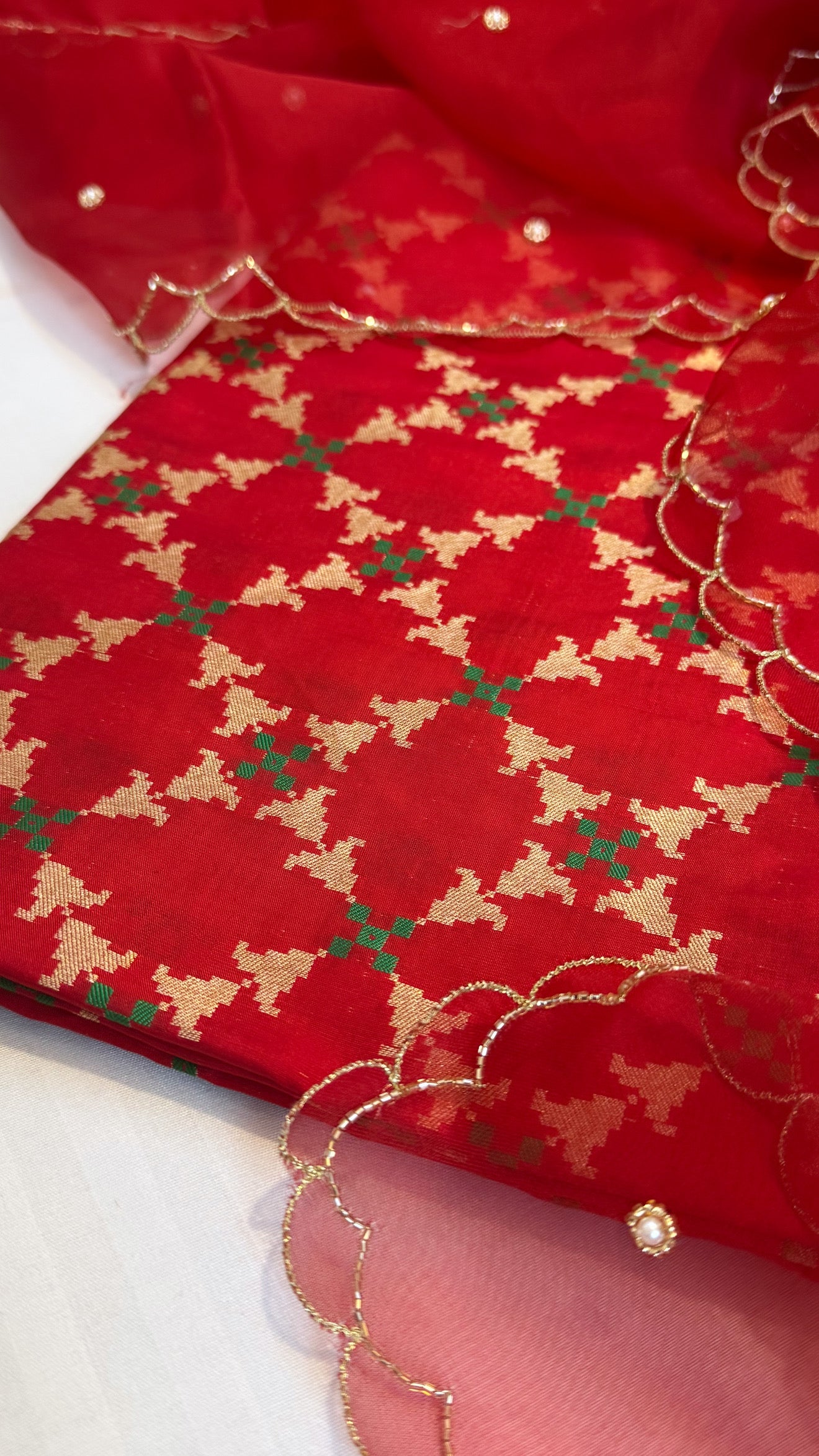 Blood red katan silk patola weaving kurta paired with kora silk scalloped duppata set