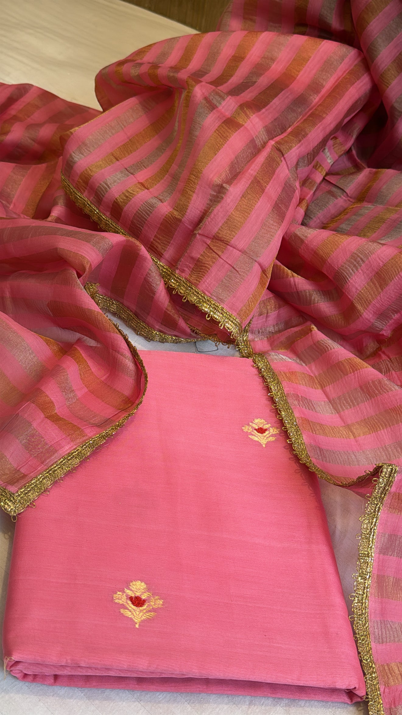 Peachy pink linen gorgette kurta paired with striped tissue silk duppata