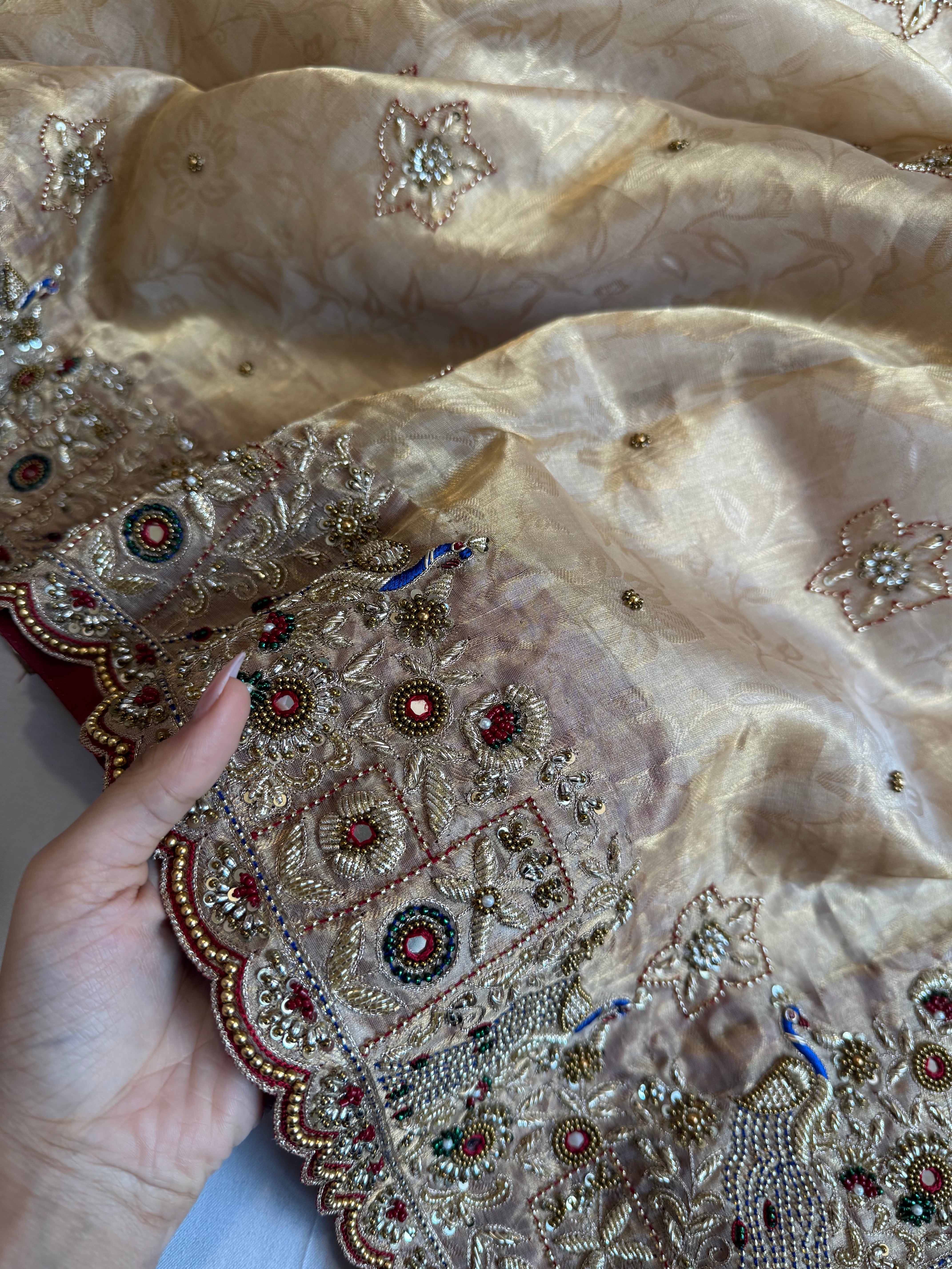 Jadau molten gold tissue silk hand embroidered peacock motif saree