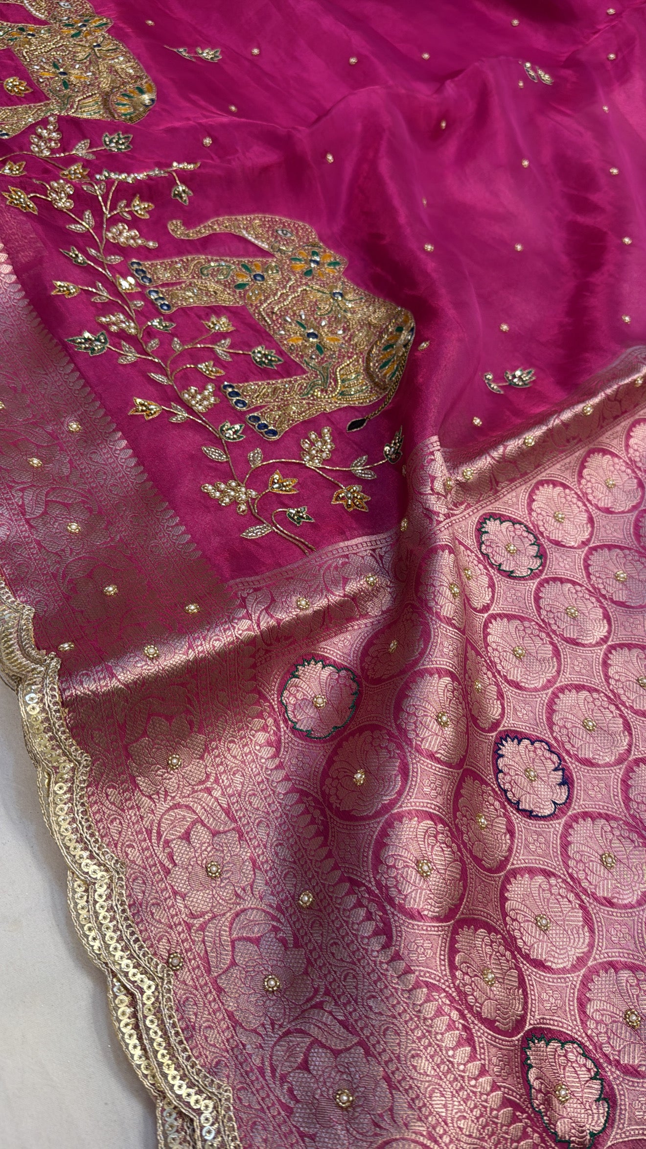 Rani pink husn tissue silk elephant motif hand embroidered saree