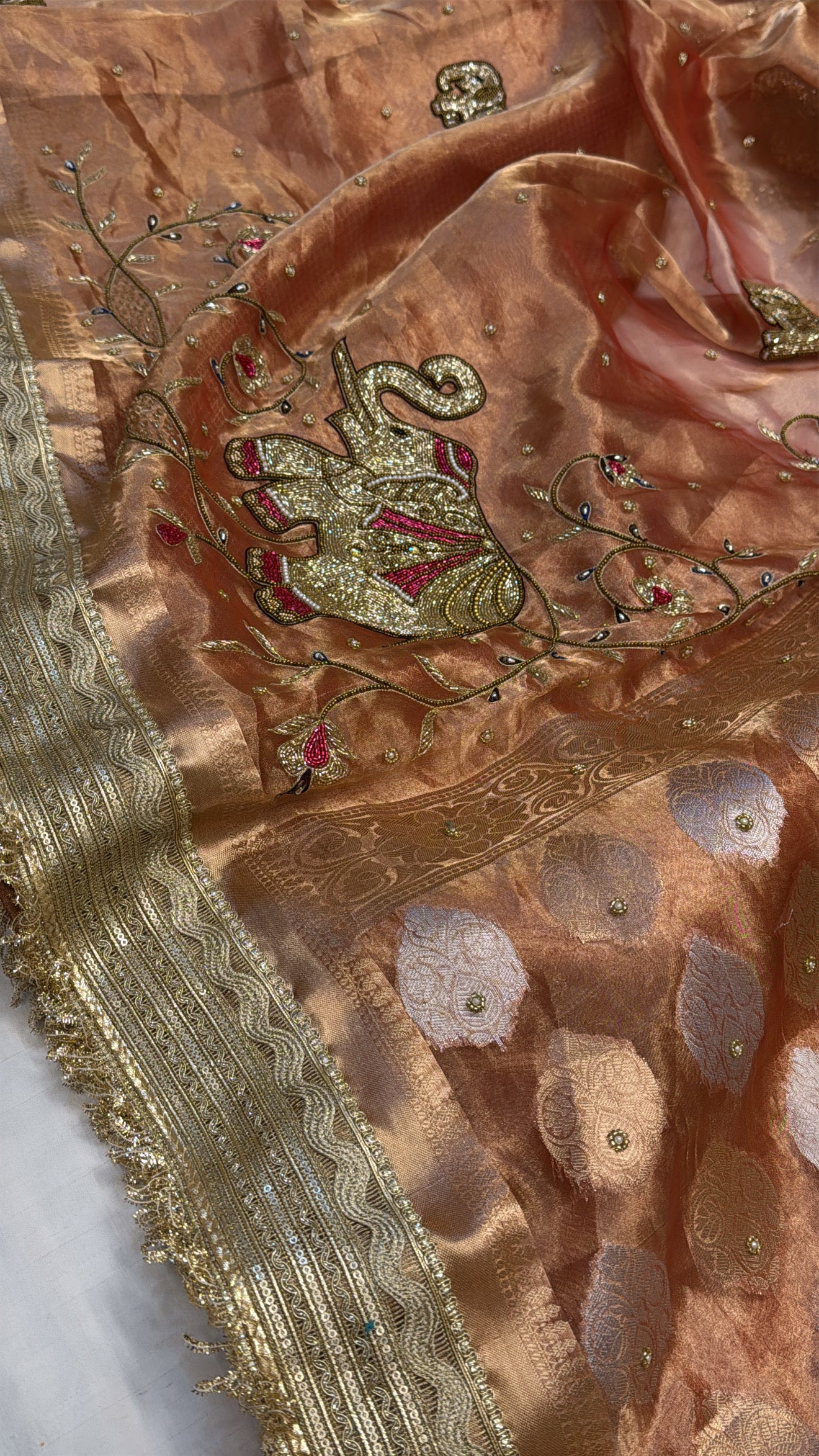 Narangi shade tissue silk dhup chao effect husn hand embroidered kadhwa saree