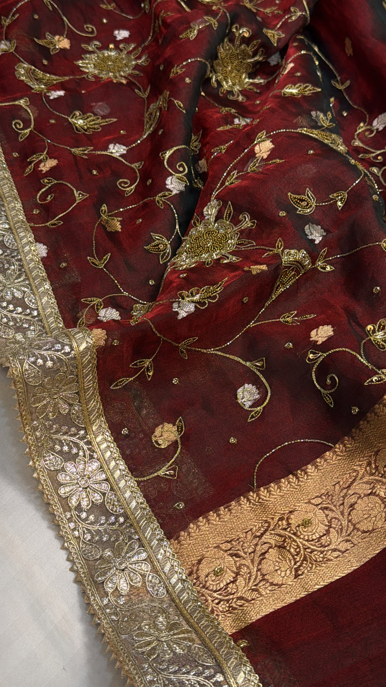 Maroonish blood red tissue silk jaalwork hand embroidered kadhwa saree
