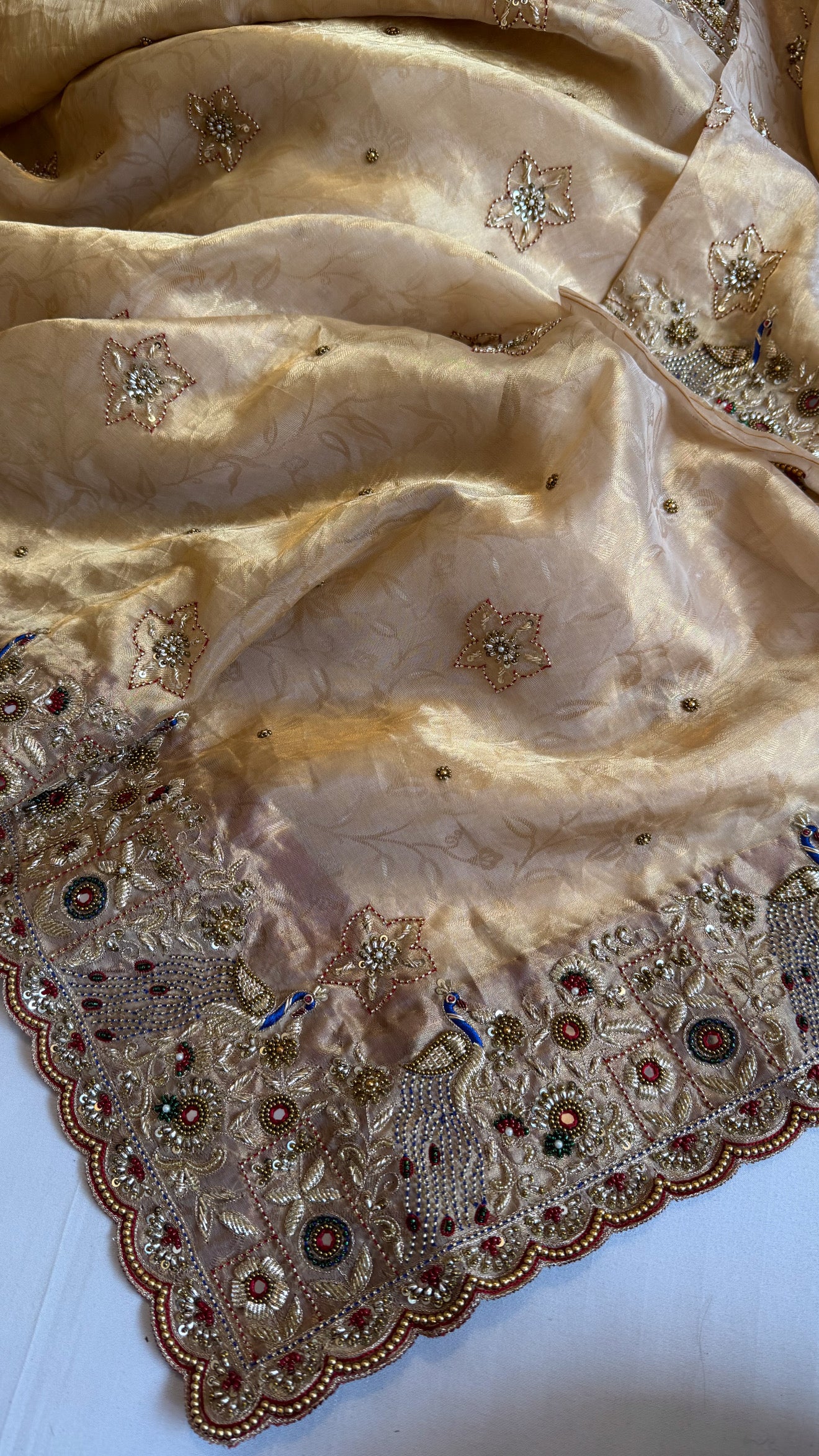Jadau molten gold tissue silk hand embroidered peacock motif saree