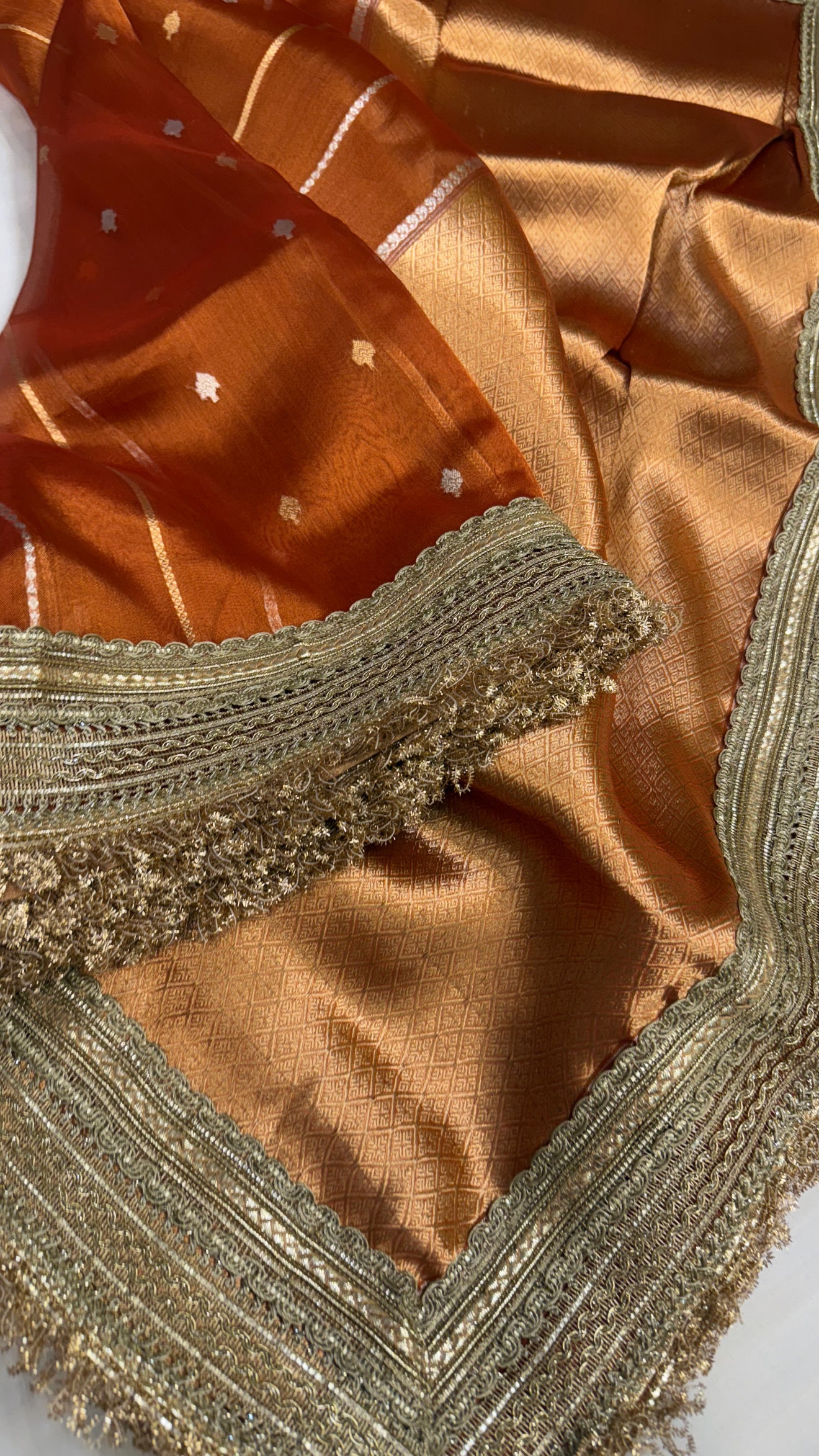 Maharani copperish orange tissue silk kadhwa buti saree