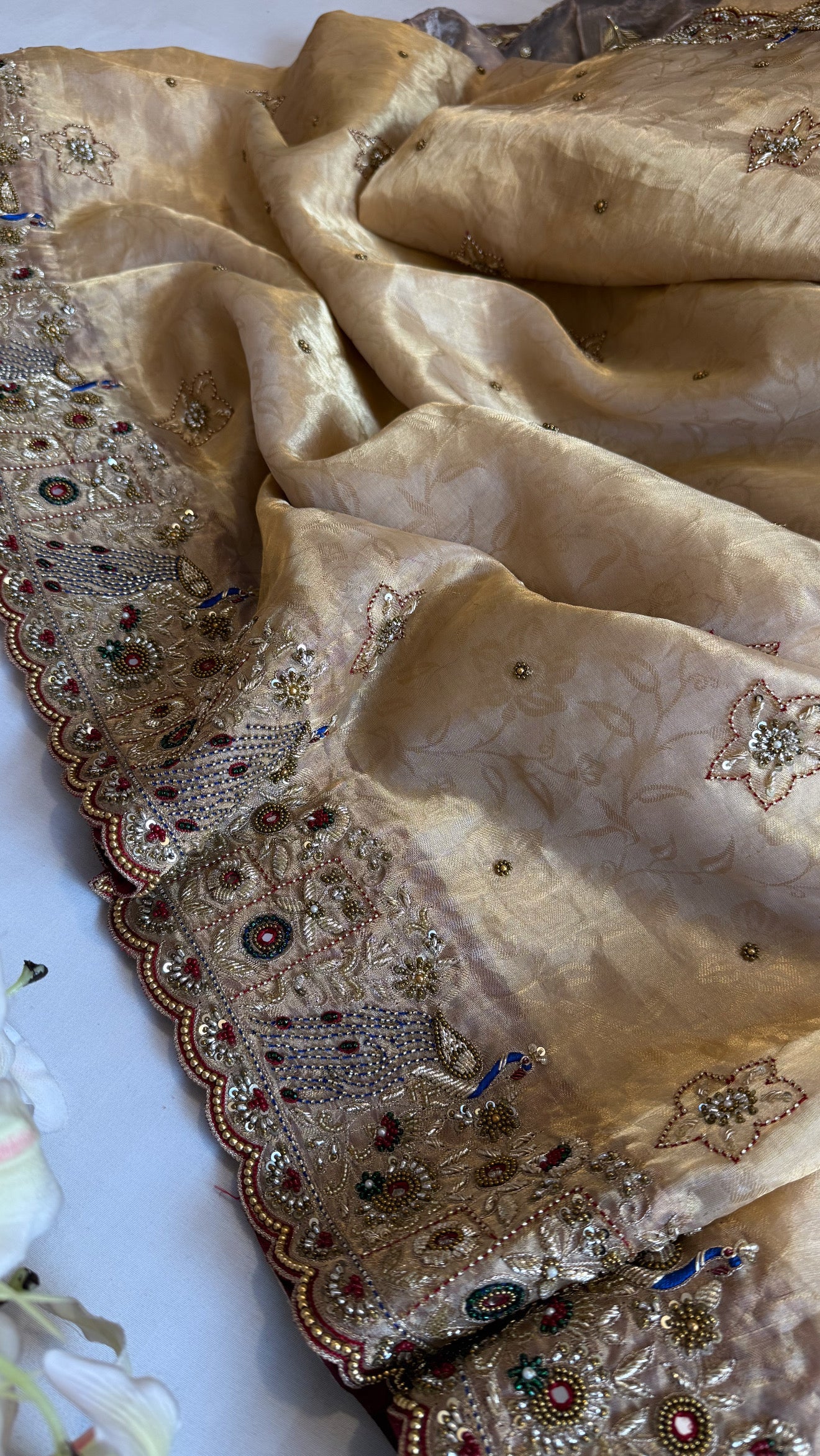 Jadau molten gold tissue silk hand embroidered peacock motif saree