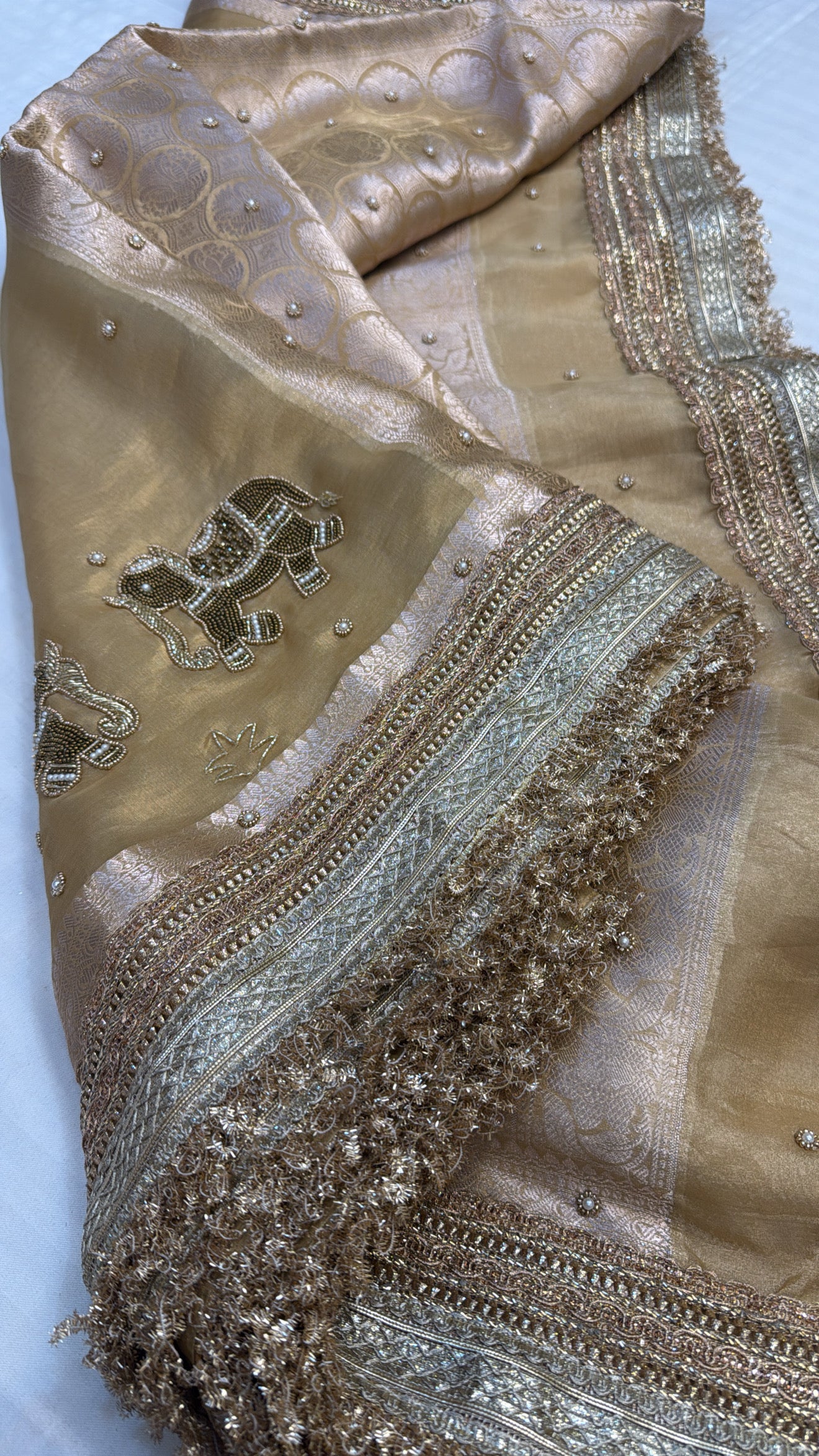 Husn champagne gold tissue silk hand embroidered saree
