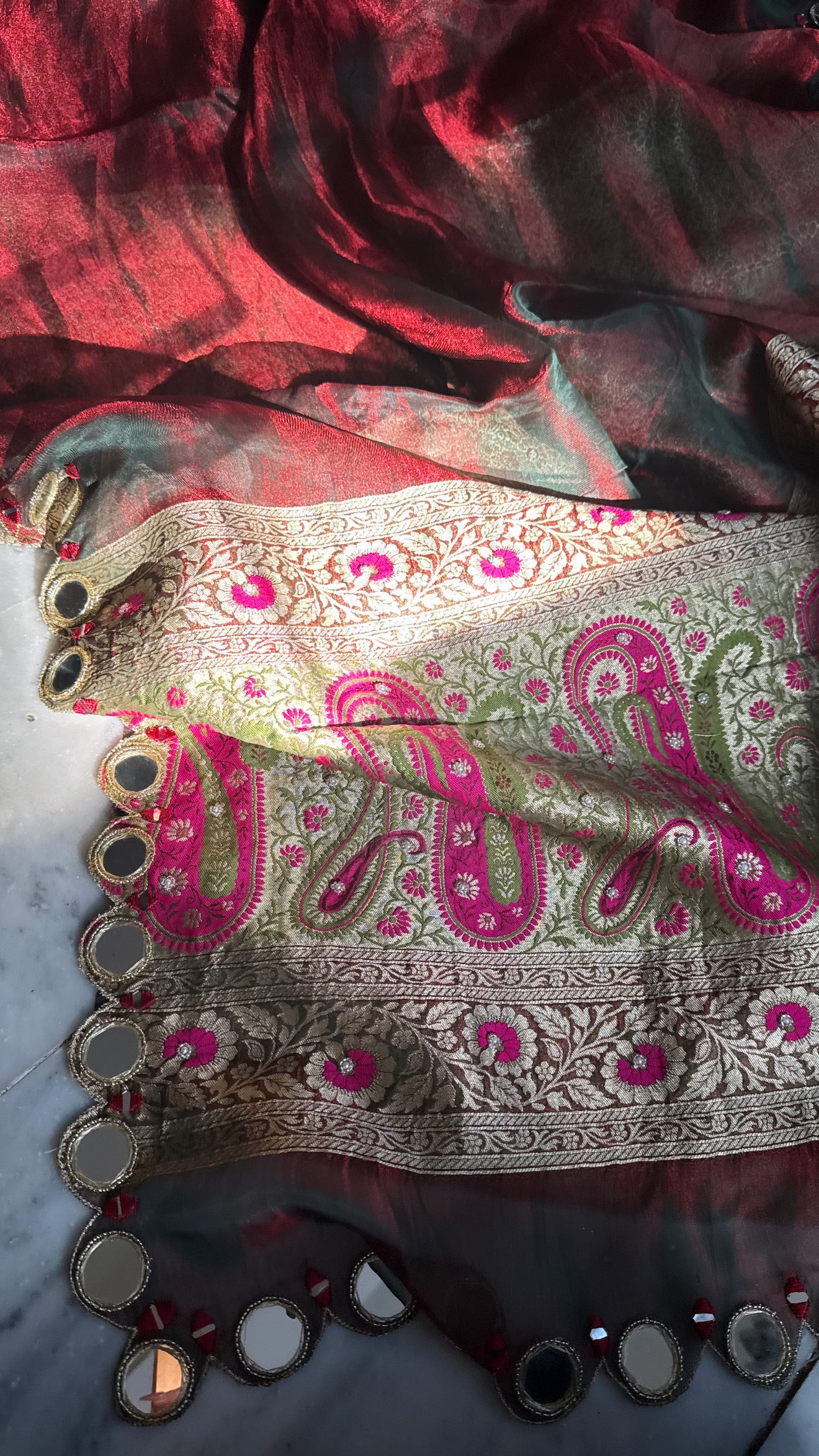 Teej special- Mirror work border maroonish red dhup chao effect tissue silk hand embroidered saree