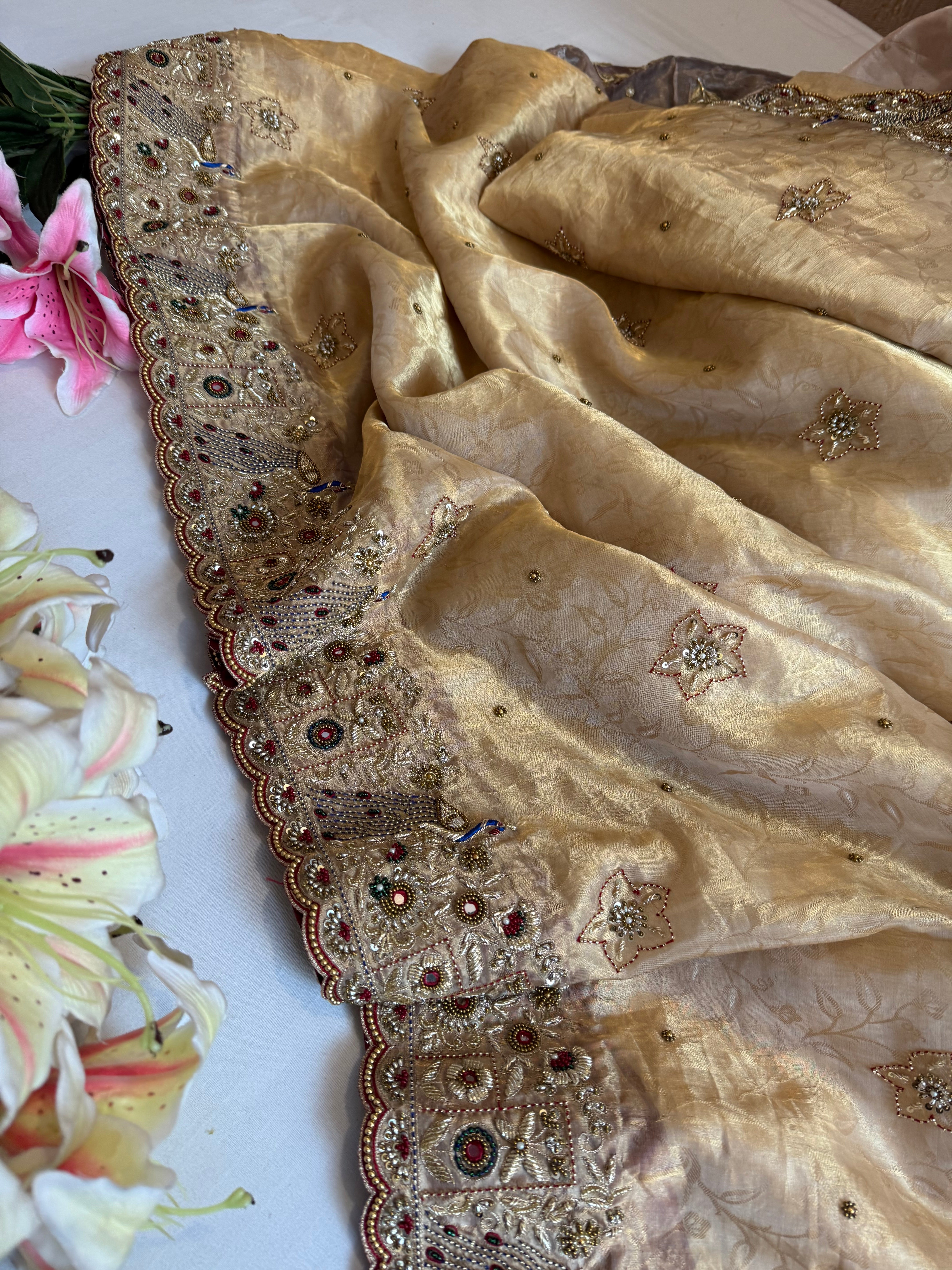 Jadau molten gold tissue silk hand embroidered peacock motif saree