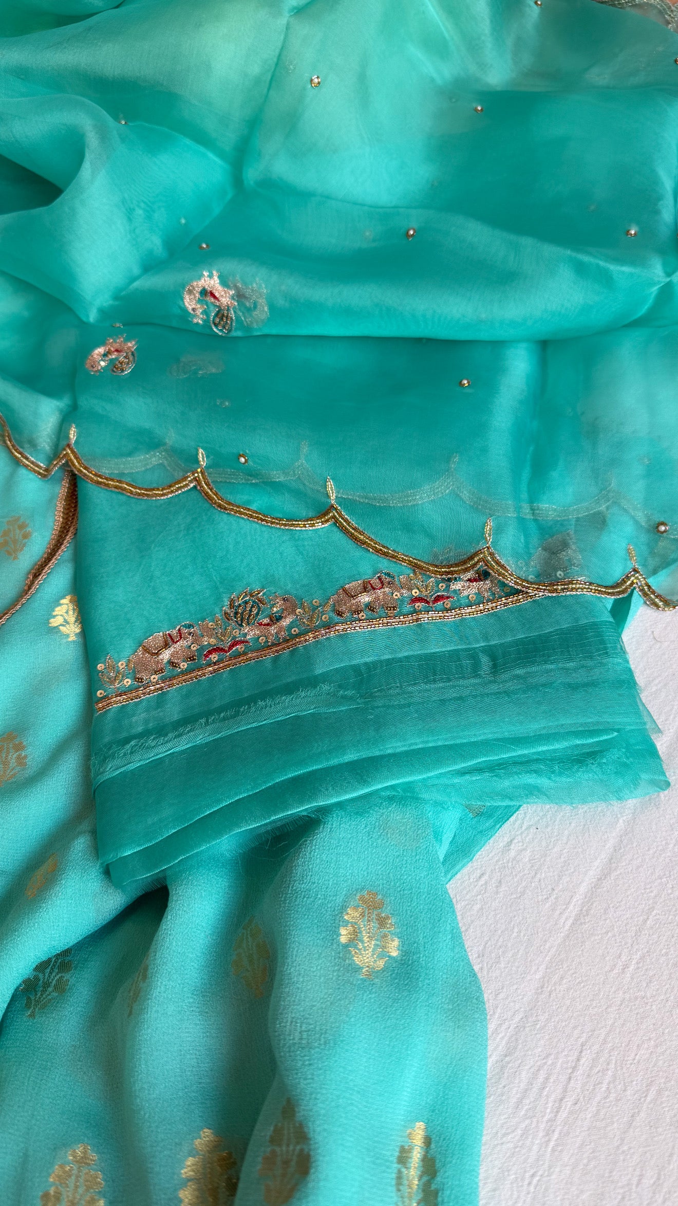 Rama blue banarasi gorgette kadhwa buti kurta paired with toy hathi motif hand embroidered scalloped duppata