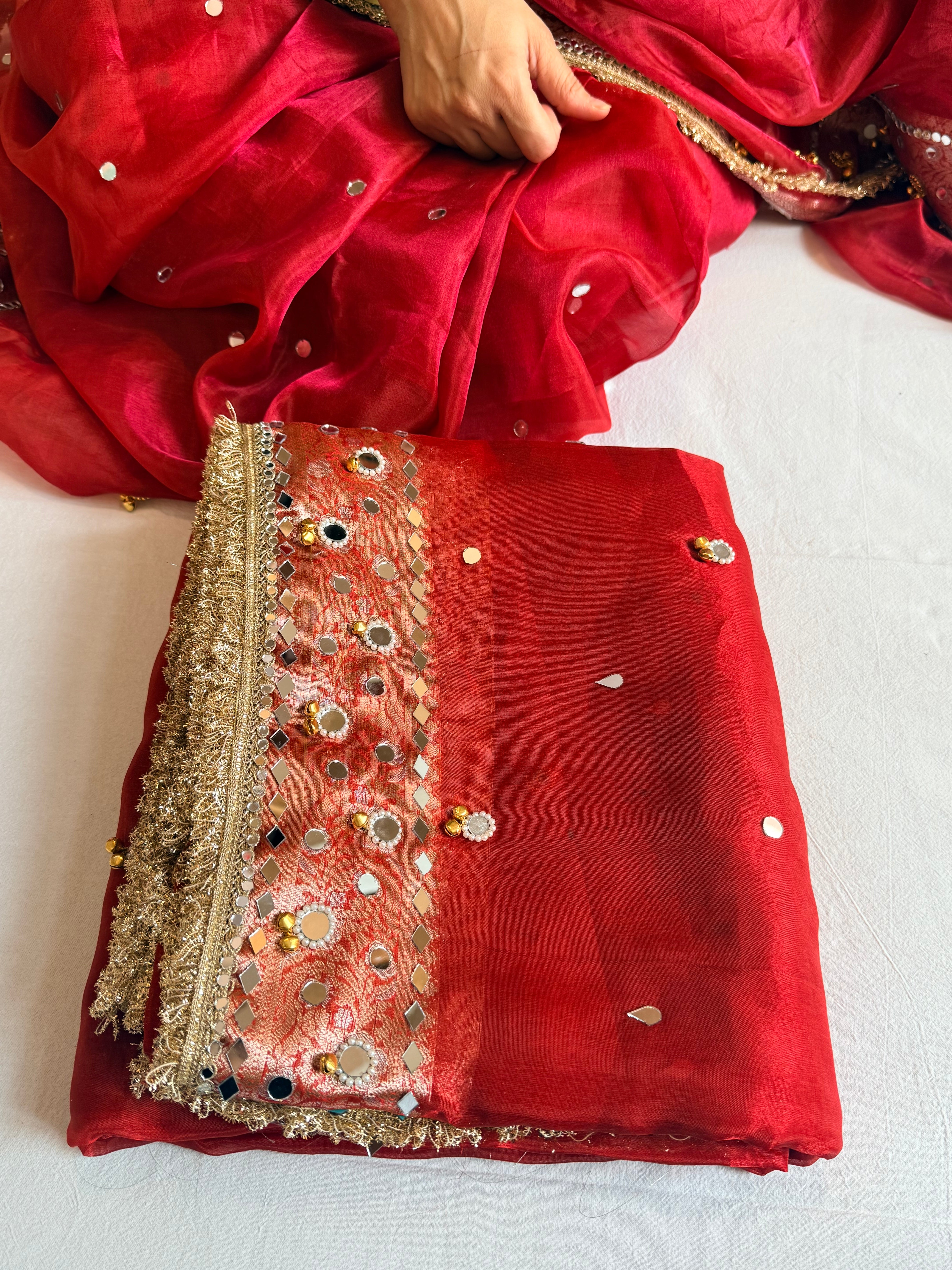 Sindoori red ghungroo and mirrorwork hand embroidered kadhwa saree