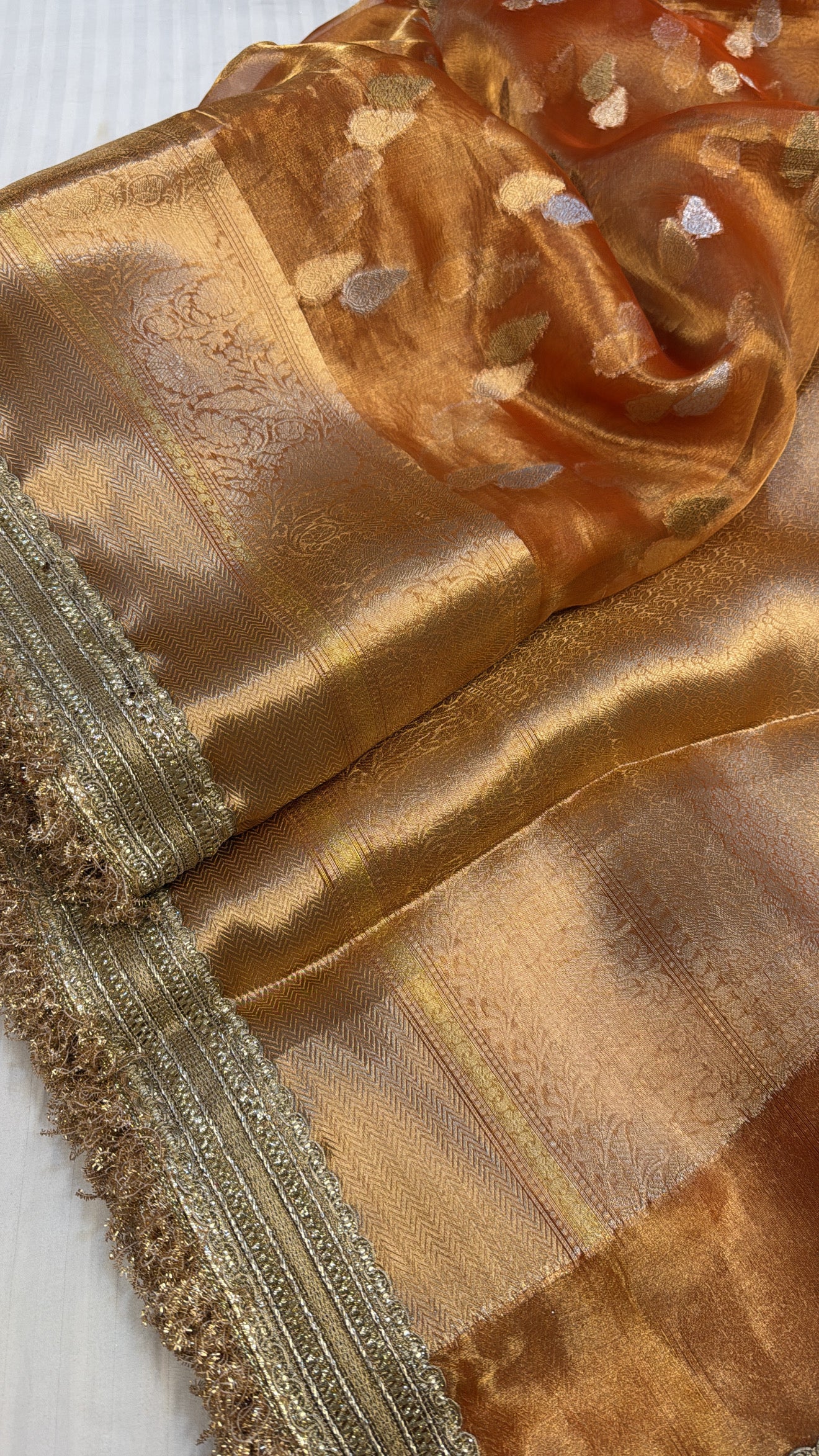 Orangey gold dhup chao effect maharani tissue silk kadhwa buti saree