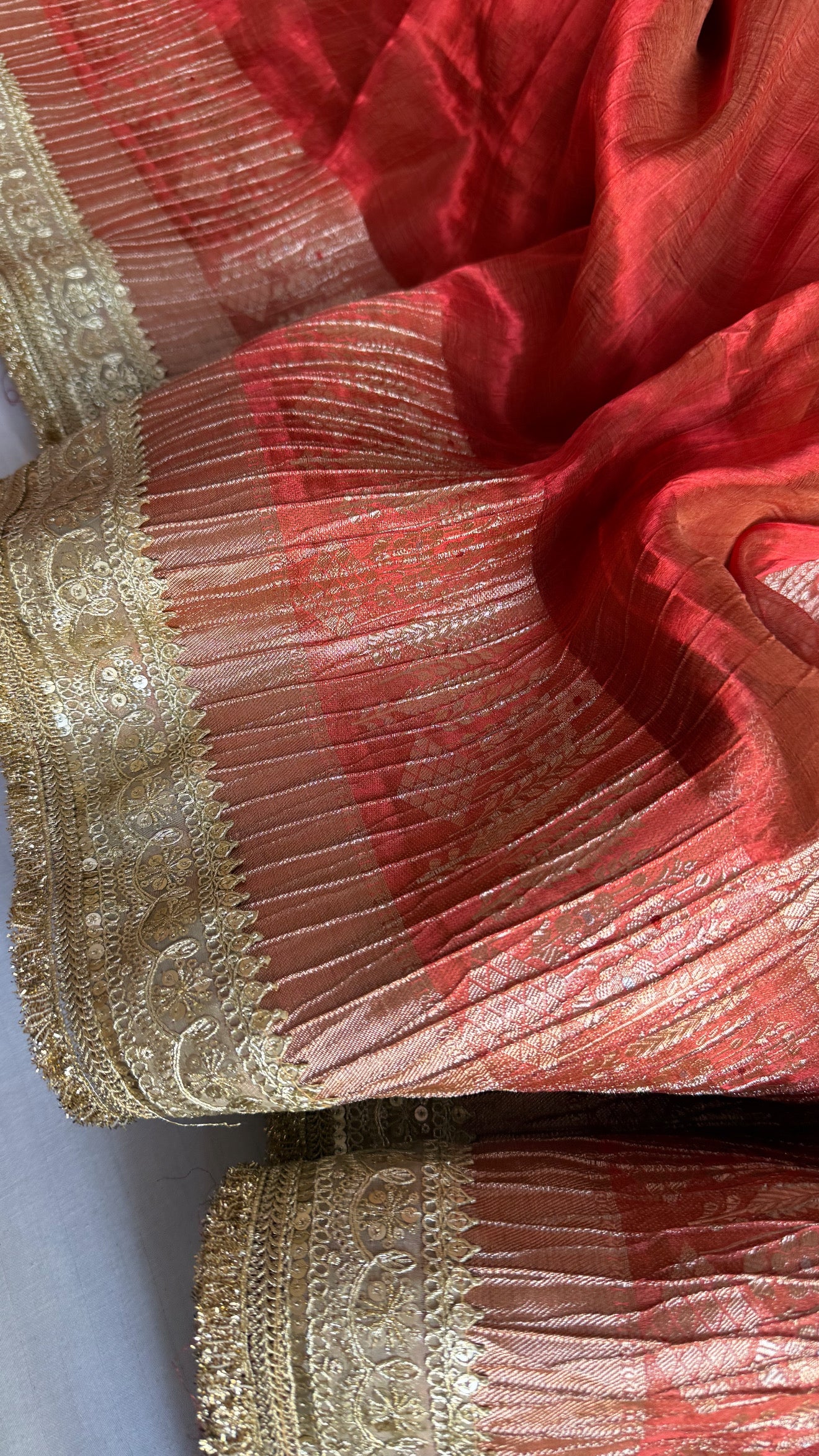 Metallic deep orange dhup chao effect pleated maharani tissue saree