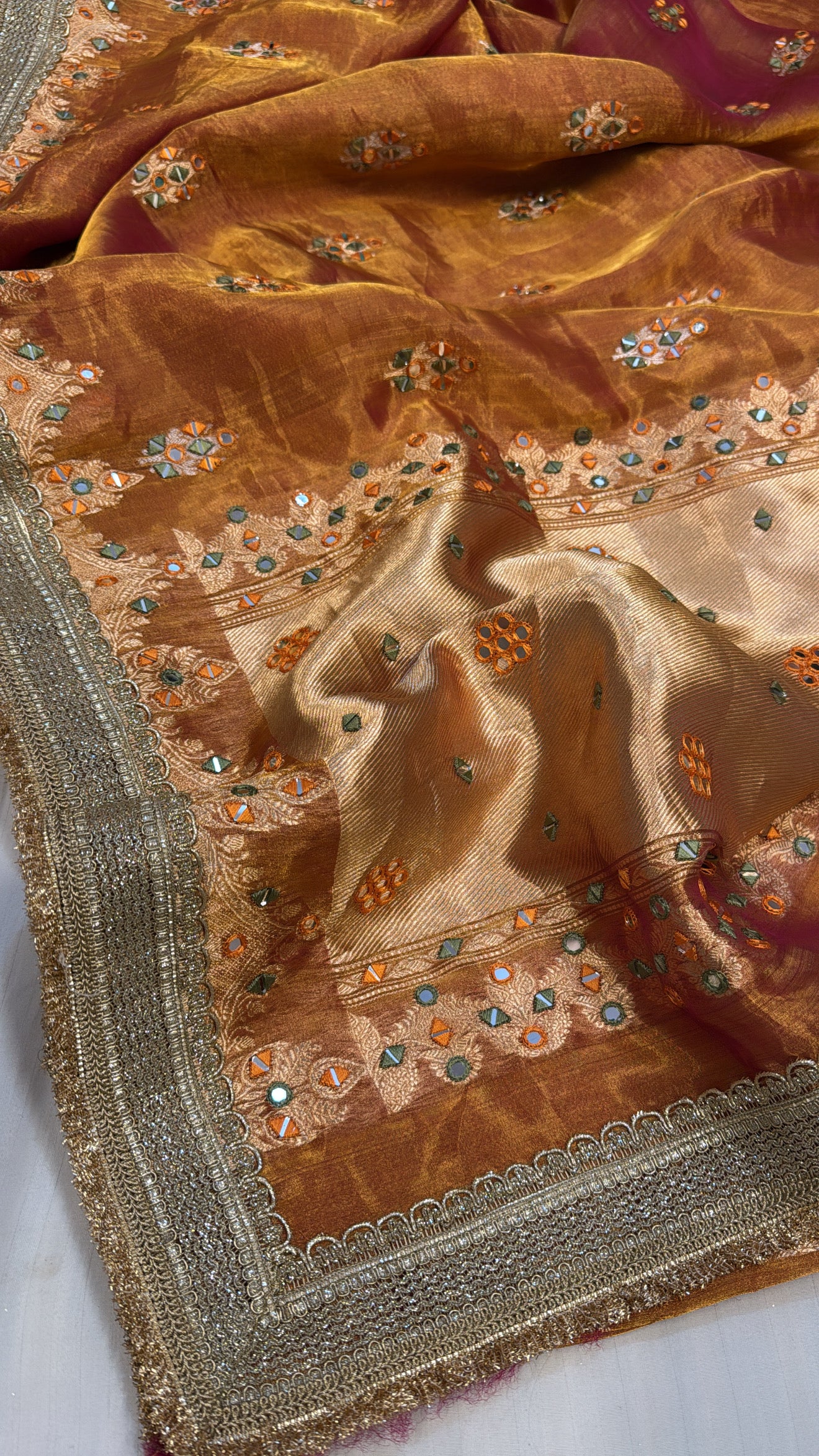 Orangey red mirror work heavy hand embroidered kadhwa buti tissue silk saree