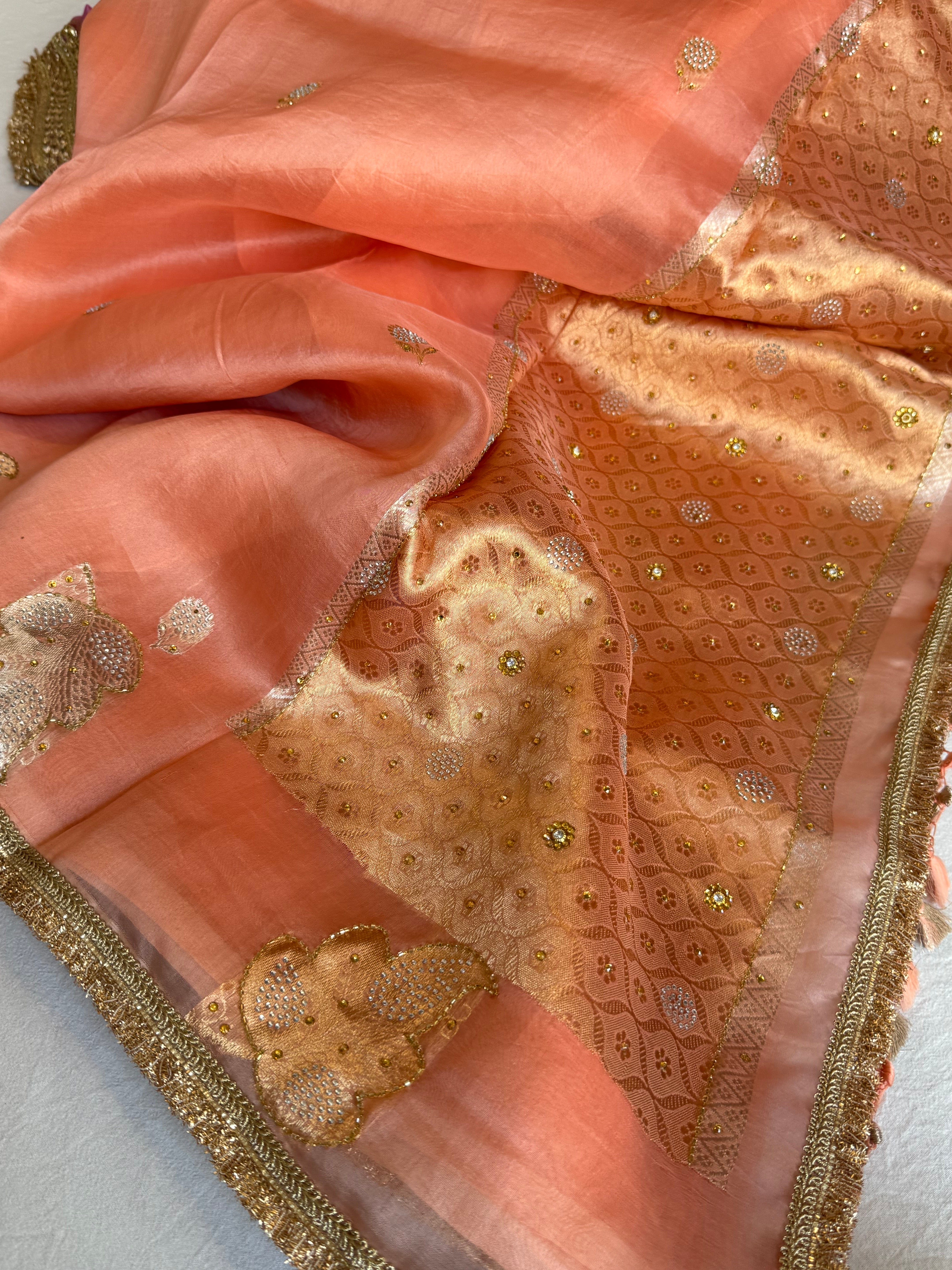 Creamy peach banarasi kora silk heavy sitara stonework kadhwa buti hand embroidered gotapatti saree