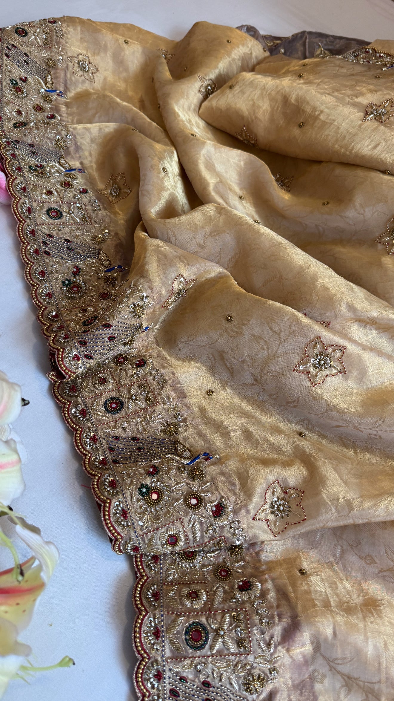 Jadau molten gold tissue silk hand embroidered peacock motif saree