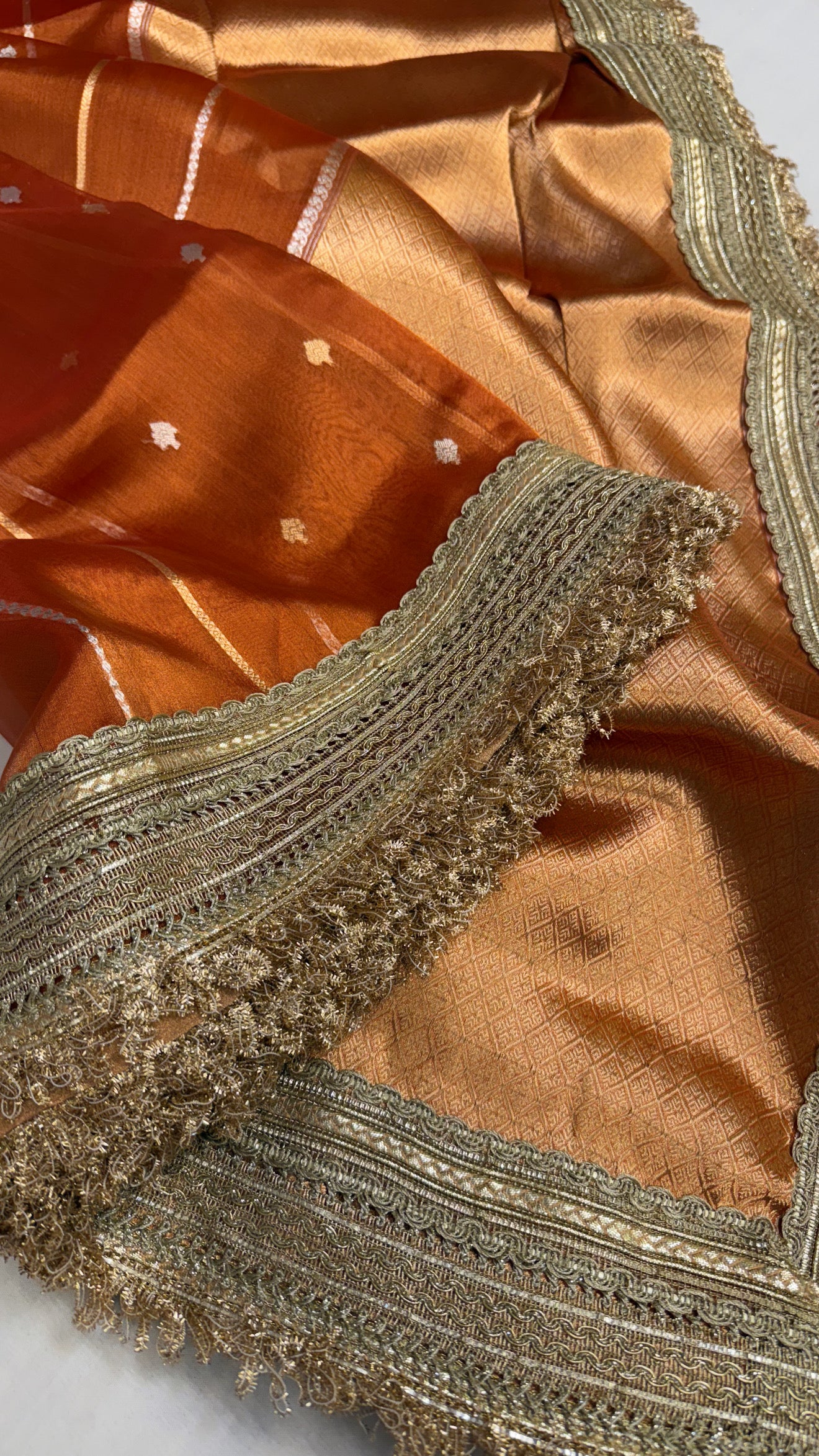 Maharani copperish orange tissue silk kadhwa buti saree