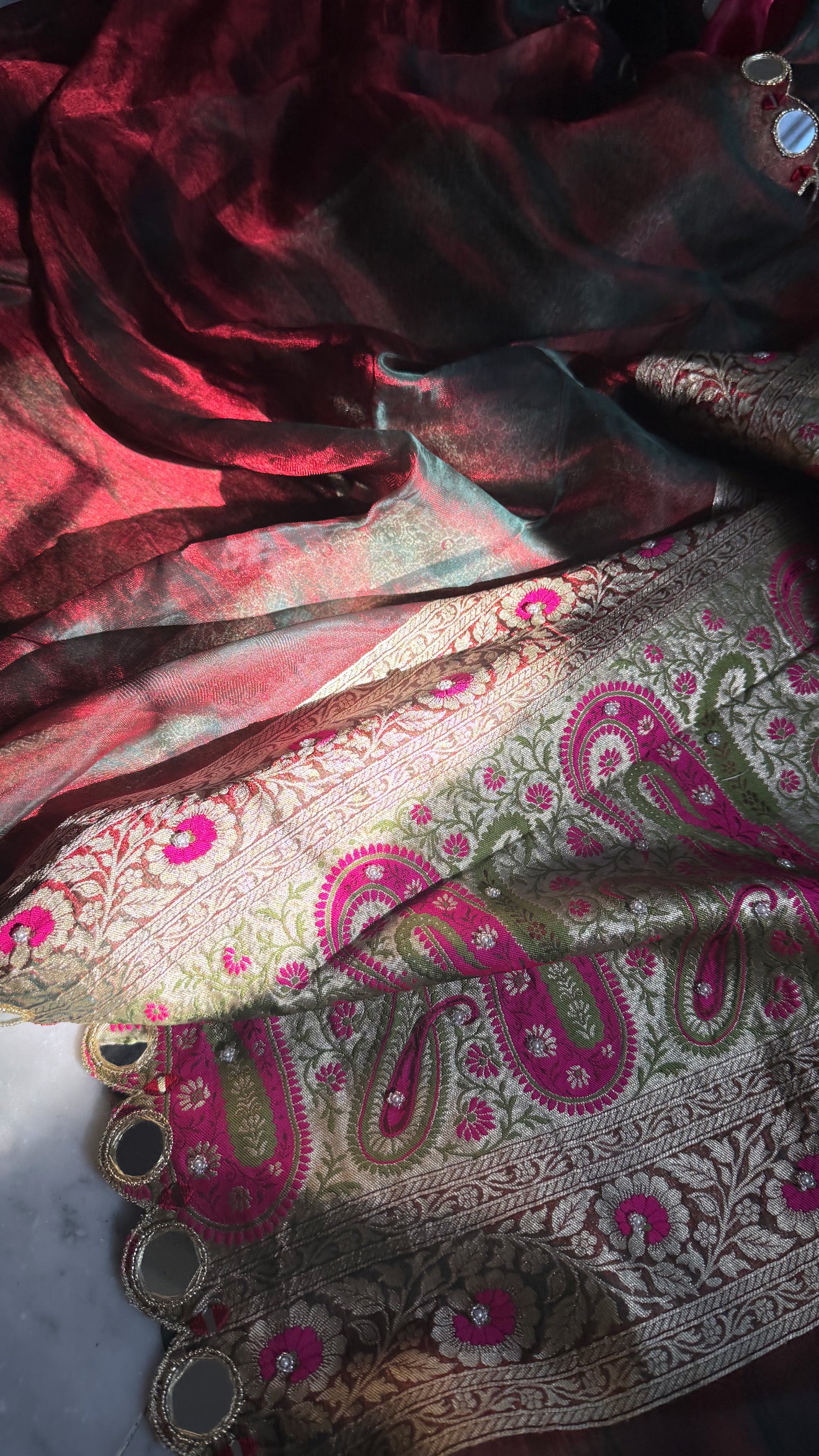 Teej special- Mirror work border maroonish red dhup chao effect tissue silk hand embroidered saree