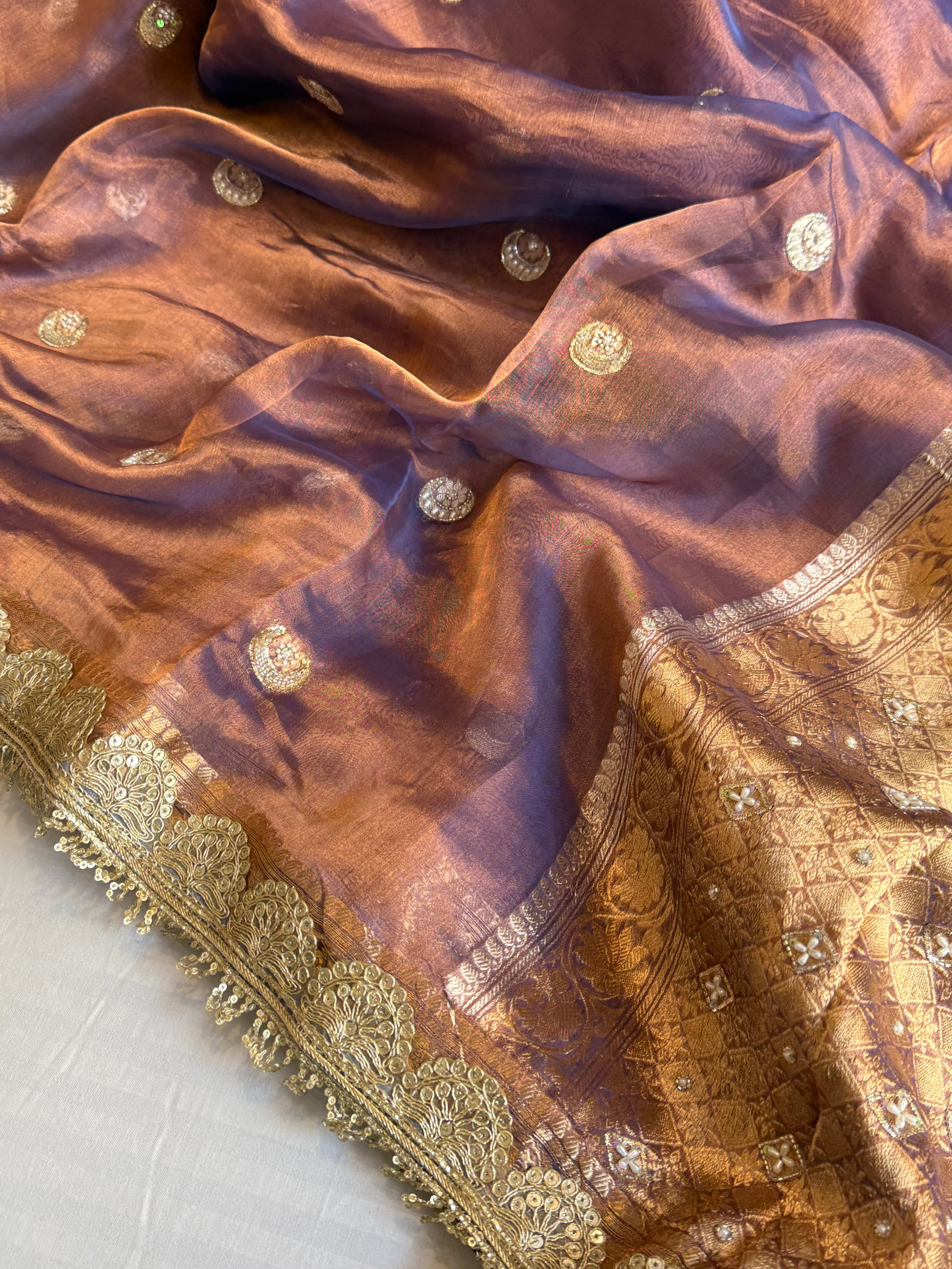 Chand tara copperish blue dhup chao effect tissue silk hand embroidered saree