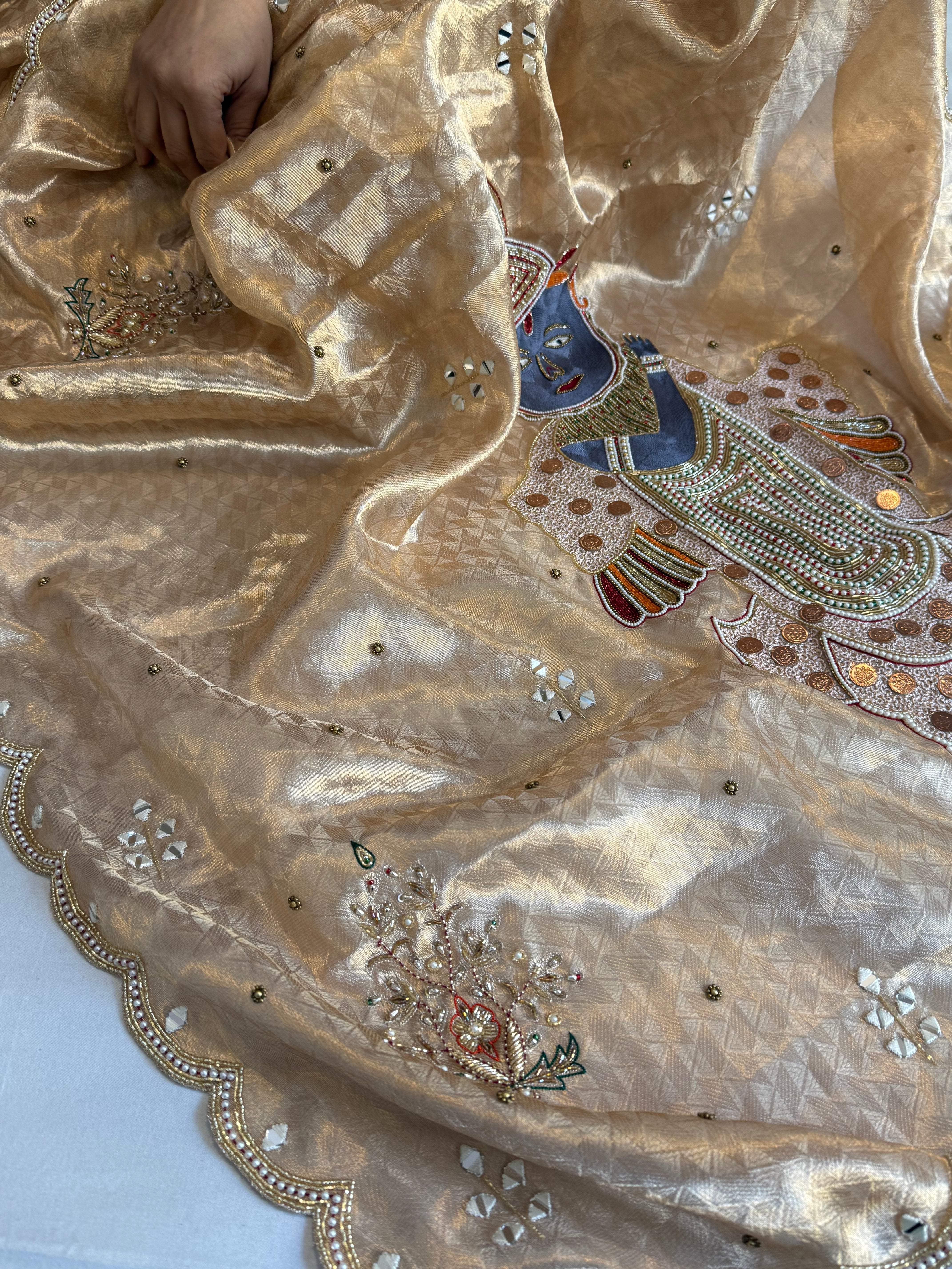 Shrinathji motif inspired molten tissue brocade kadhwa weaving hand embroidered saree