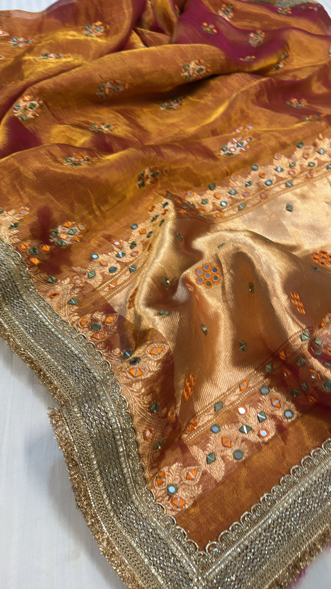 Orangey red mirror work heavy hand embroidered kadhwa buti tissue silk saree