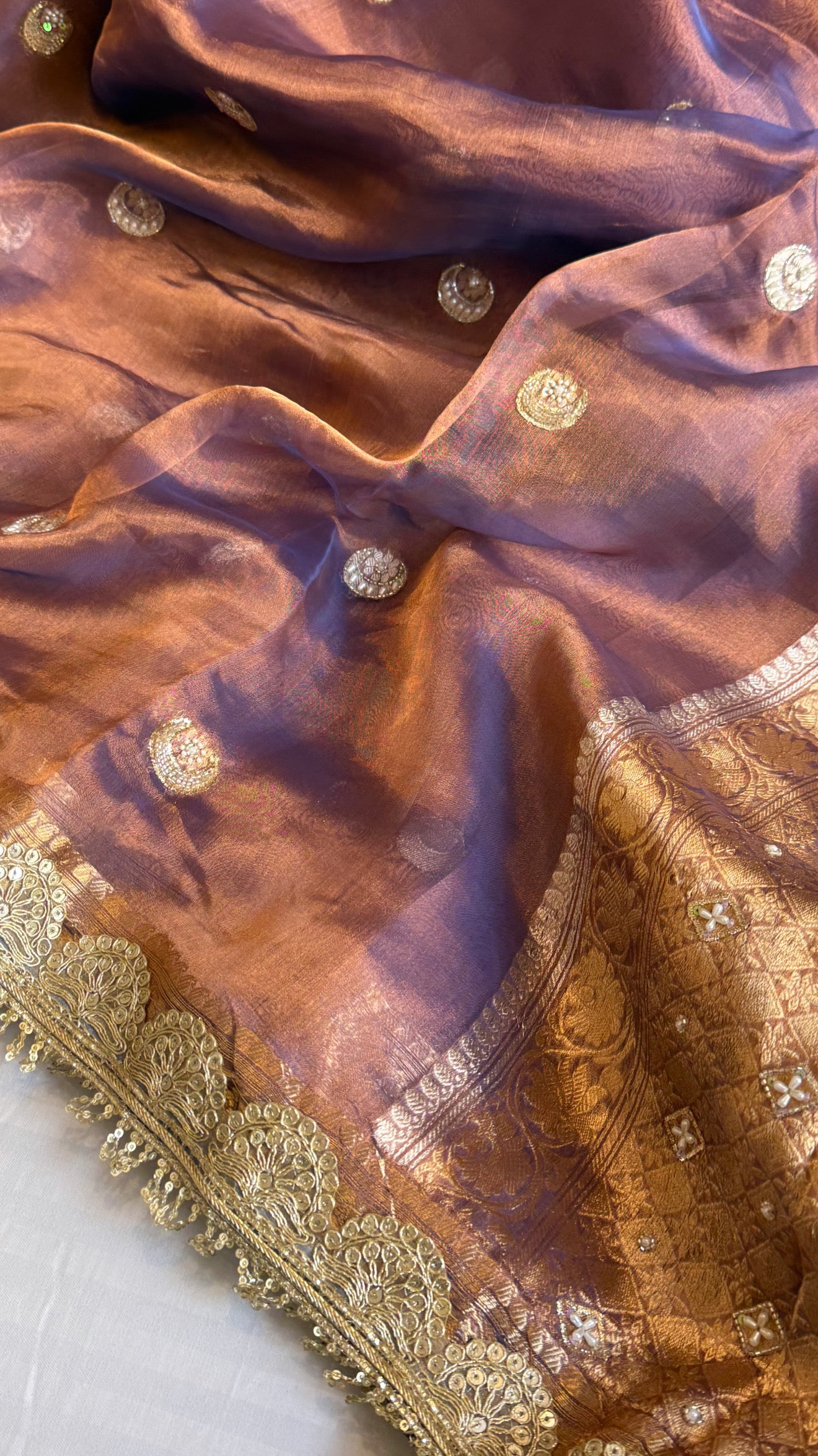 Chand tara copperish blue dhup chao effect tissue silk hand embroidered saree