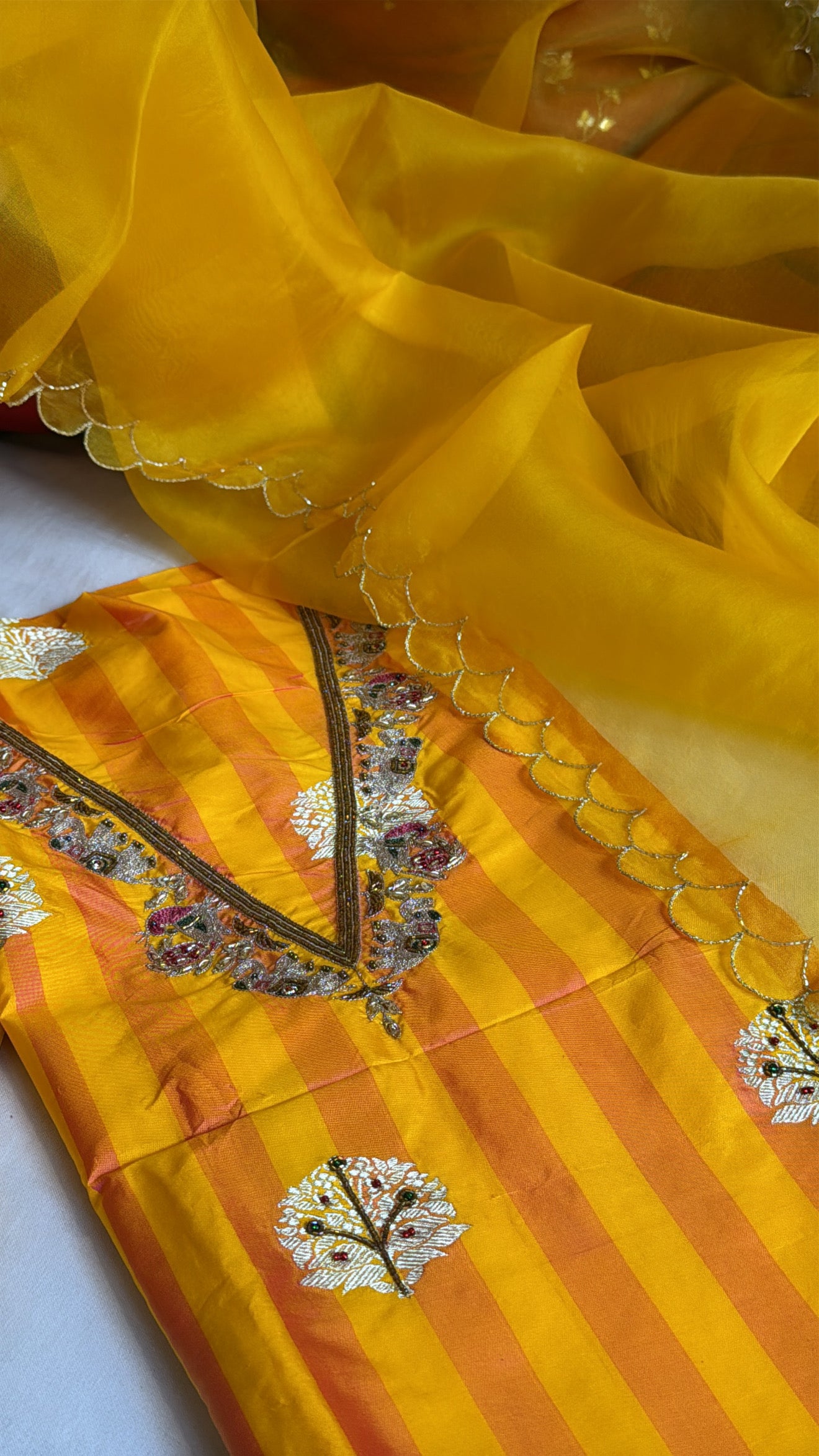 Haldi yellow-orange dhup chao effect katan silk striped kurta paired with kora silk scalloped duppata set