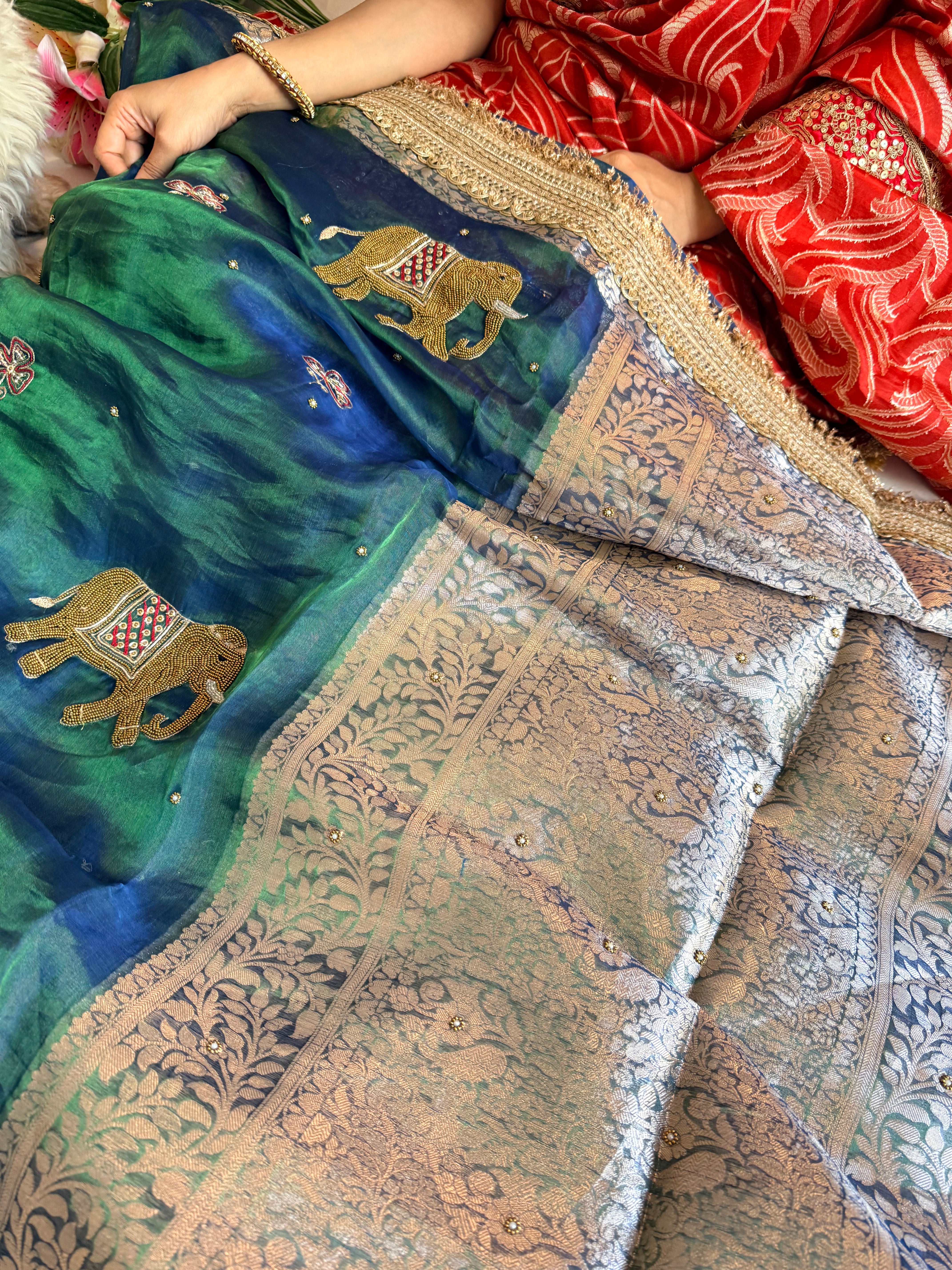 Elephant motif peacock blue dhup chao effect tissue silk hand embroidered saree