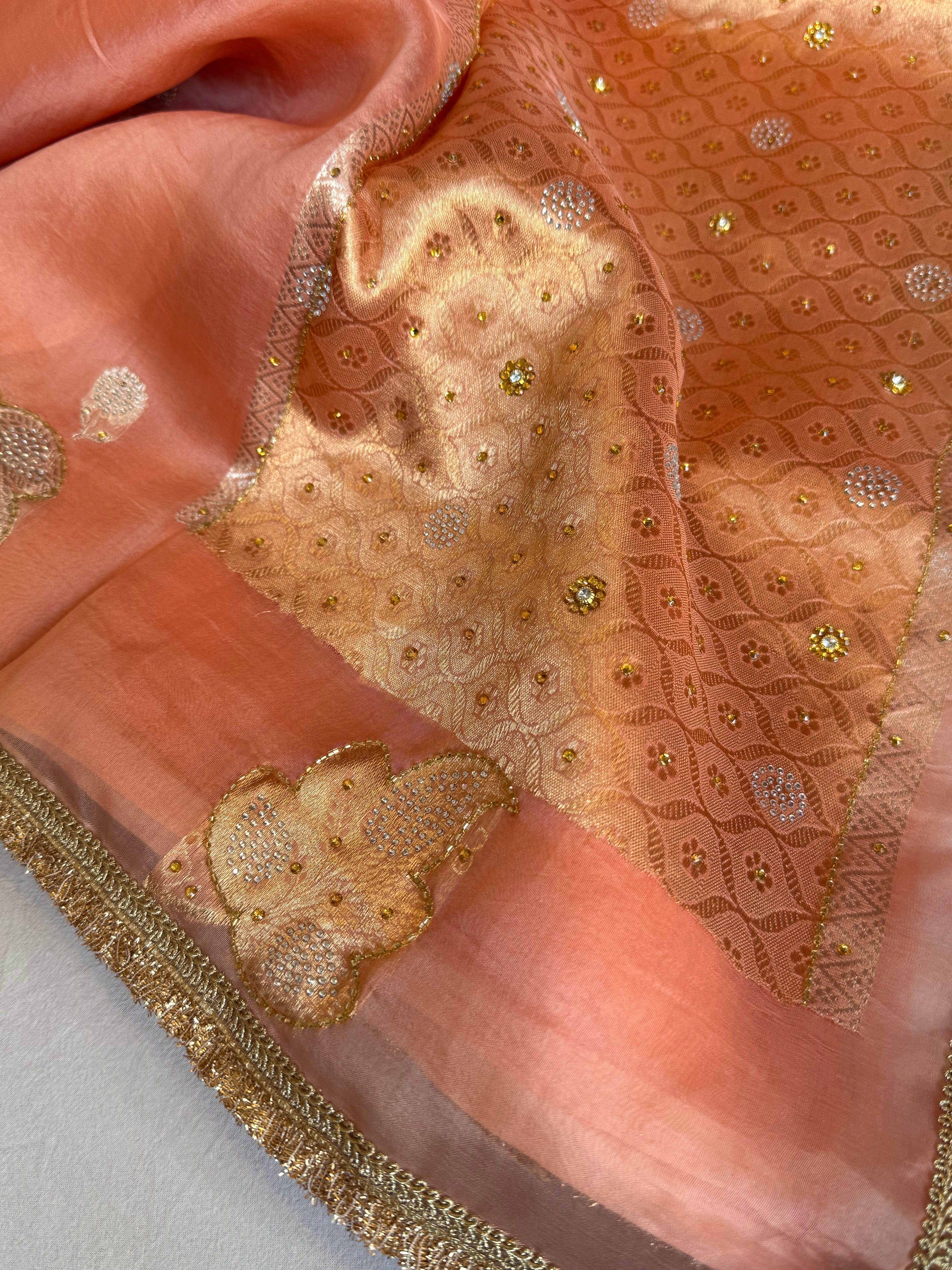 Creamy peach banarasi kora silk heavy sitara stonework kadhwa buti hand embroidered gotapatti saree