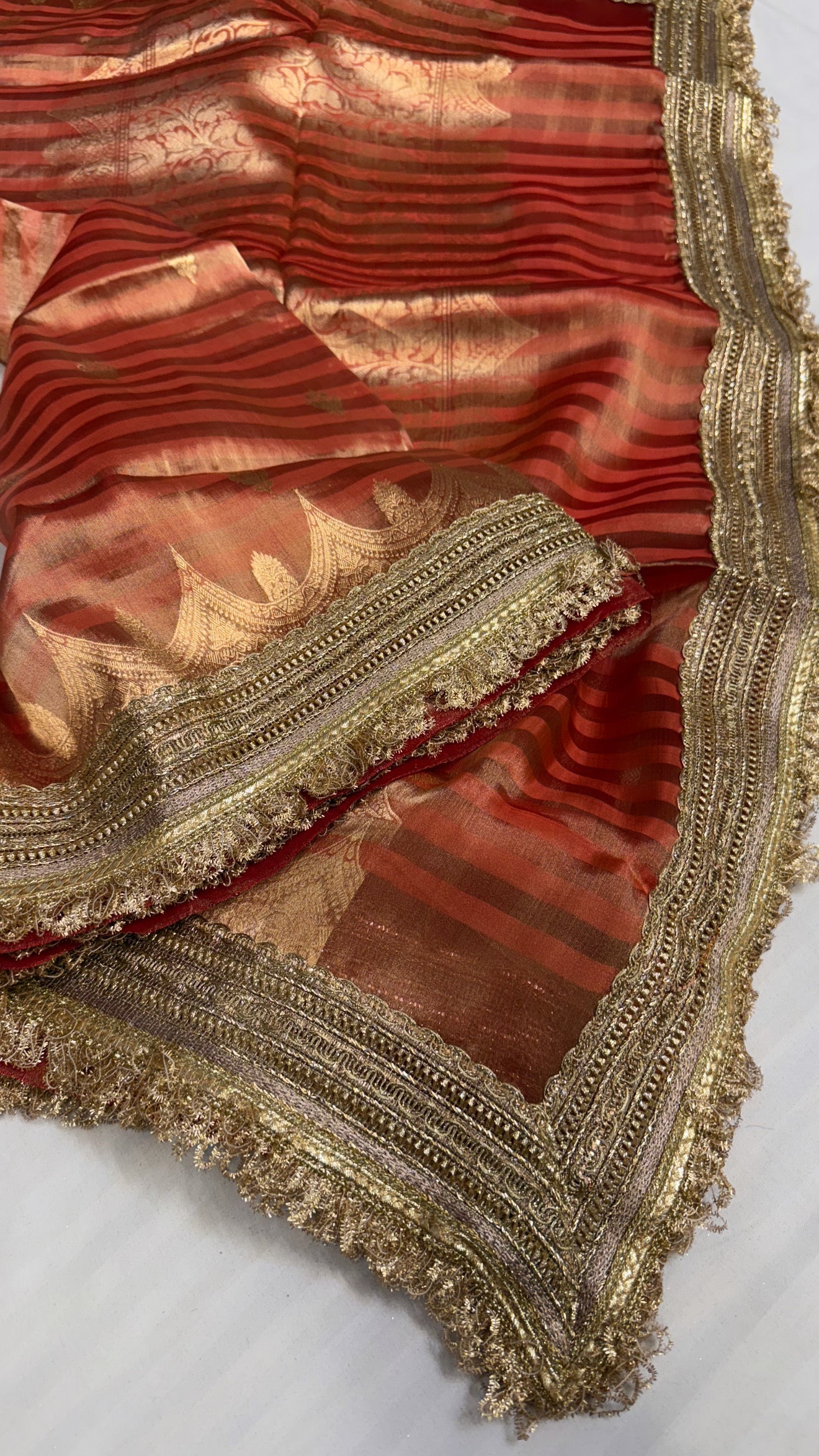 Maharani rust red tissue silk striped kadhwa saree