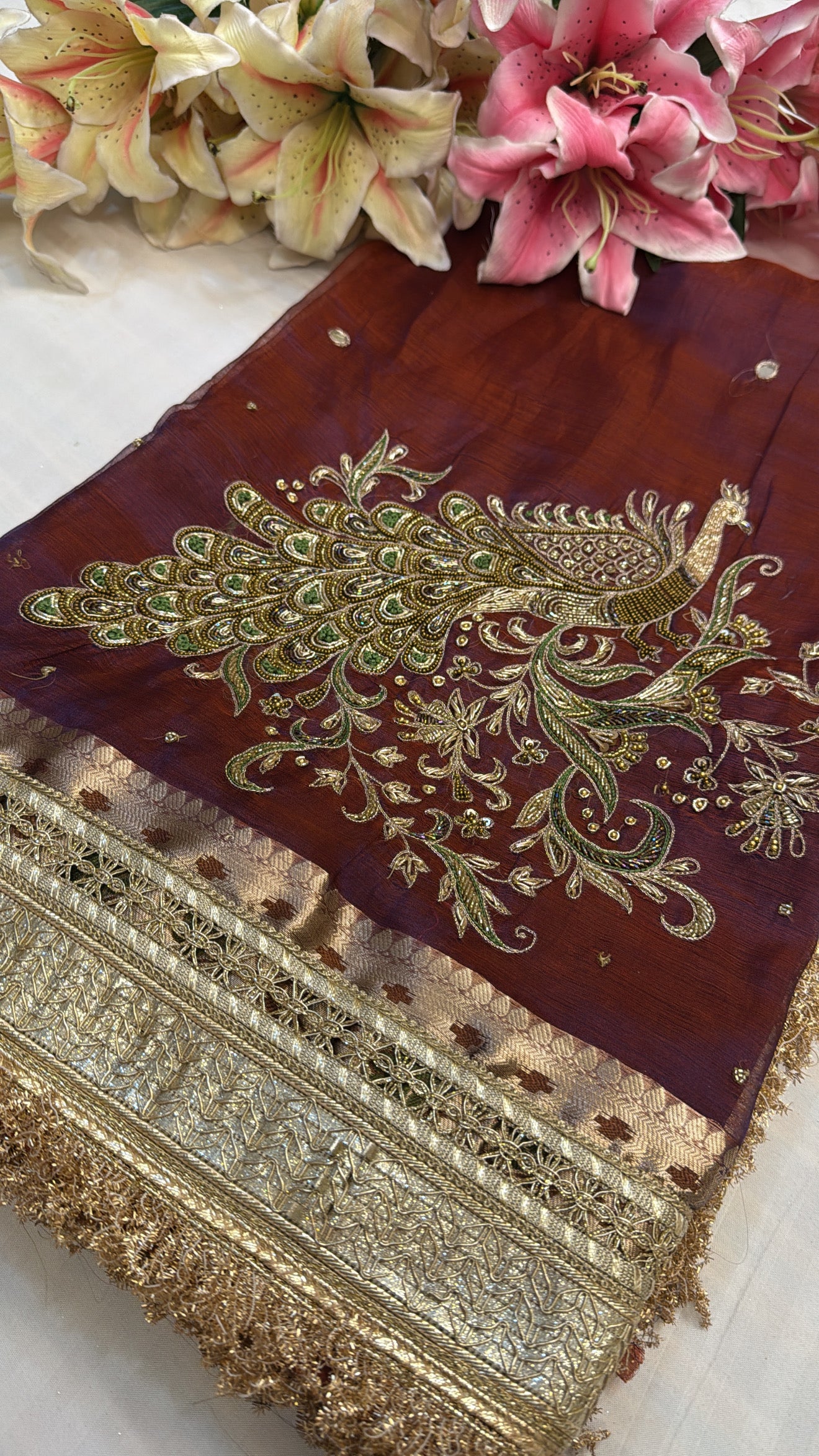 Maroonish-blue dhup chao effect tissue silk peacock motif hand embroidered saree