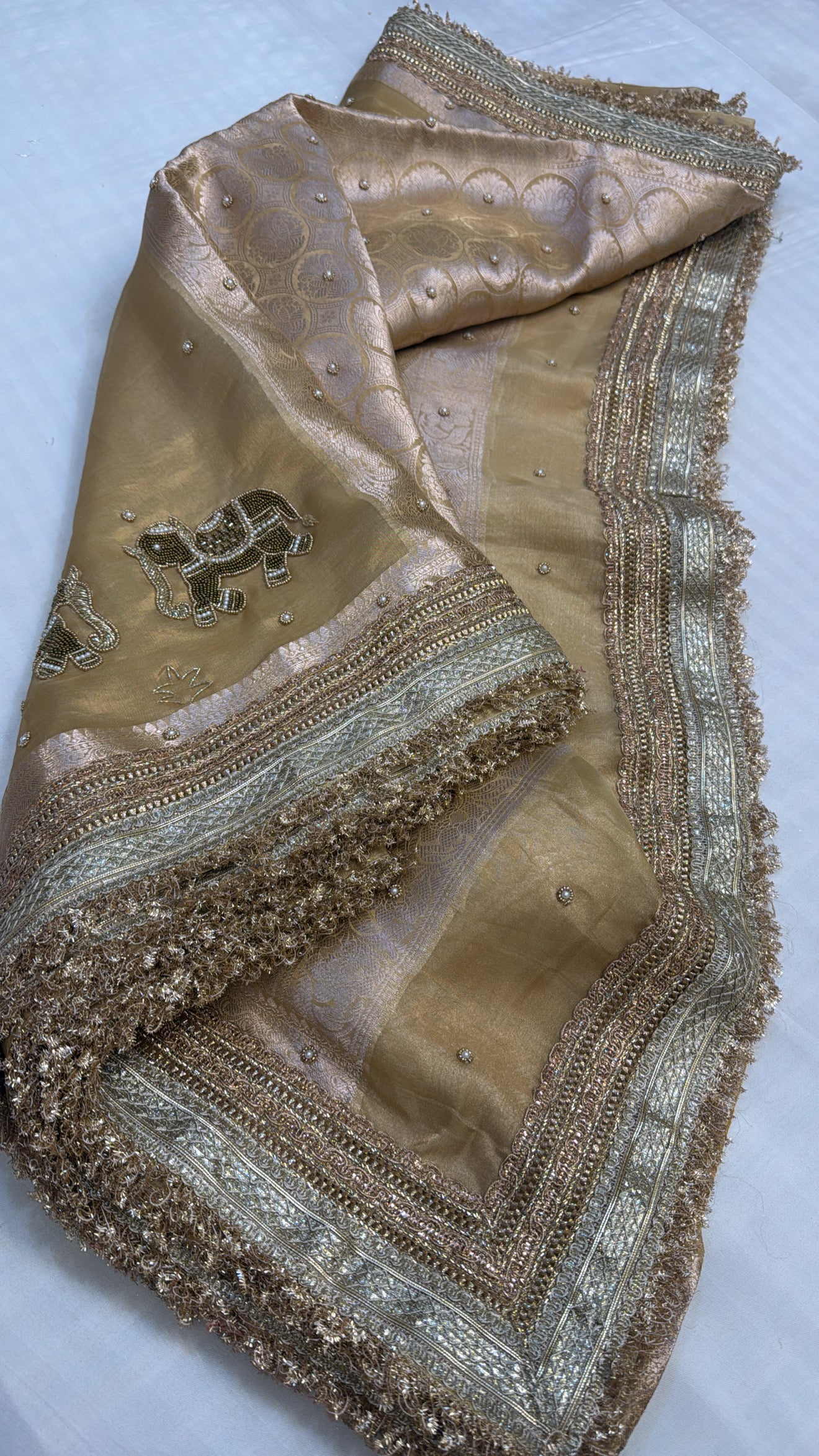 Husn champagne gold tissue silk hand embroidered saree