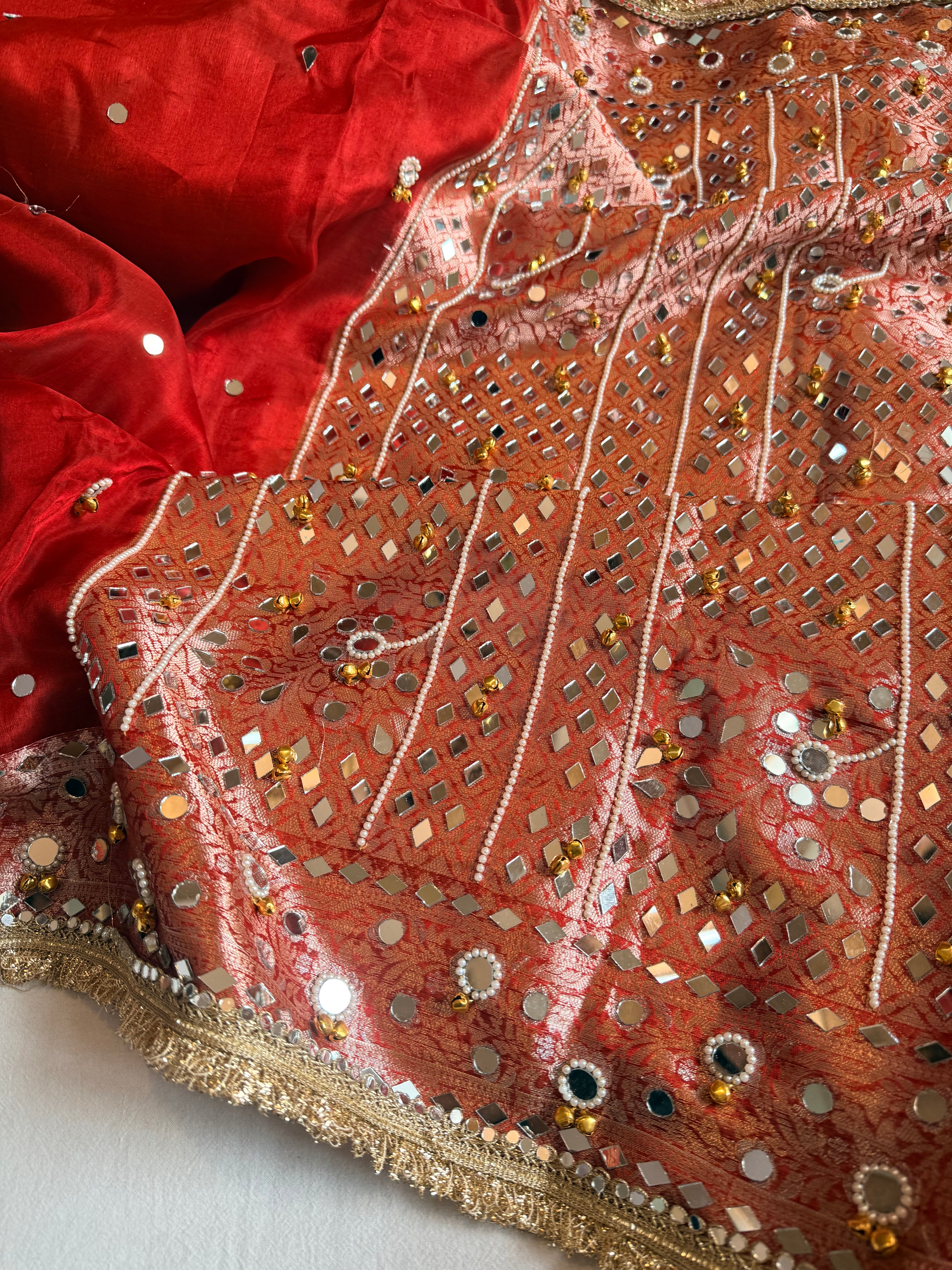 Sindoori red ghungroo and mirrorwork hand embroidered kadhwa saree