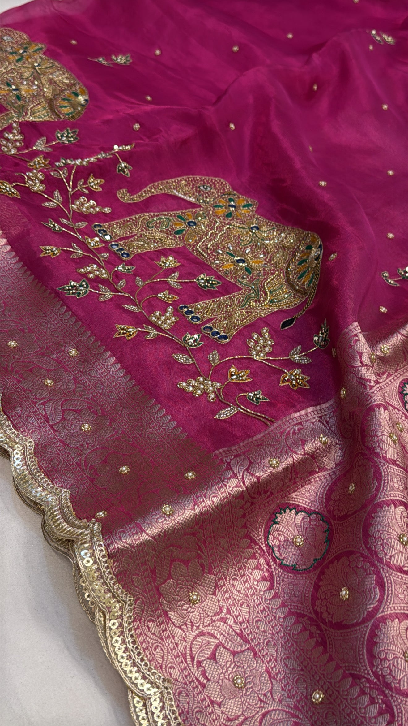 Rani pink husn tissue silk elephant motif hand embroidered saree