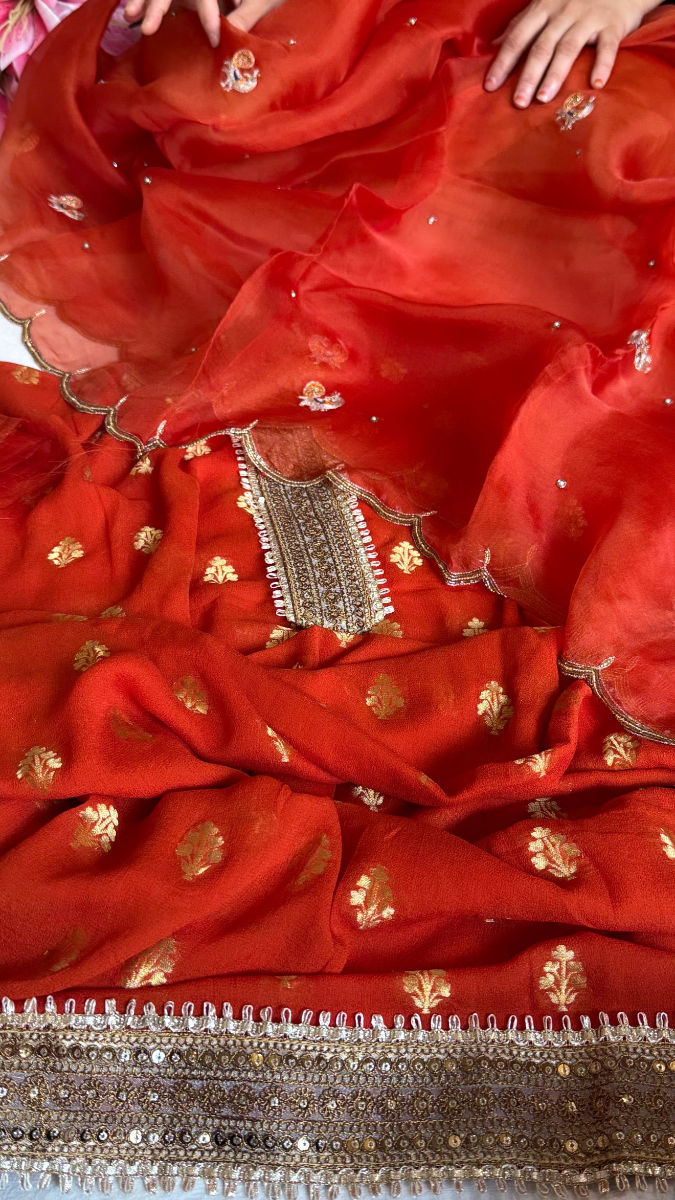 Burnt orange banarasi gorgette kadhwa buti kurta paired with toy hathi motif hand embroidered scalloped kora duppata