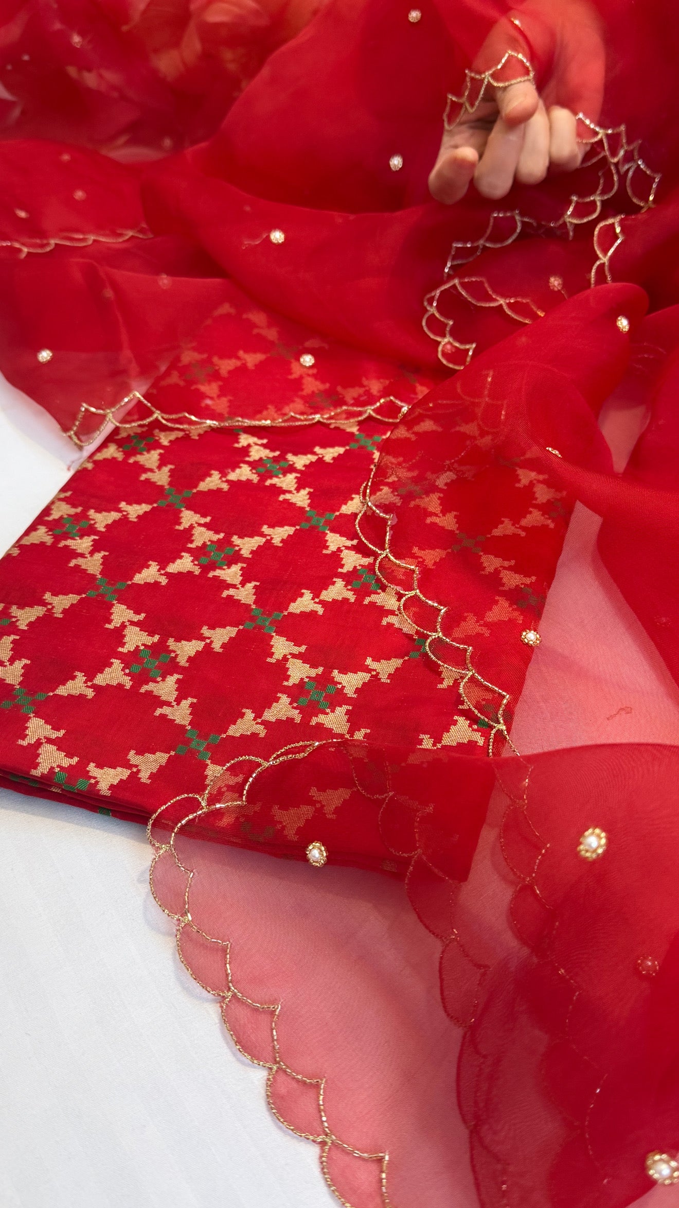 Blood red katan silk patola weaving kurta paired with kora silk scalloped duppata set