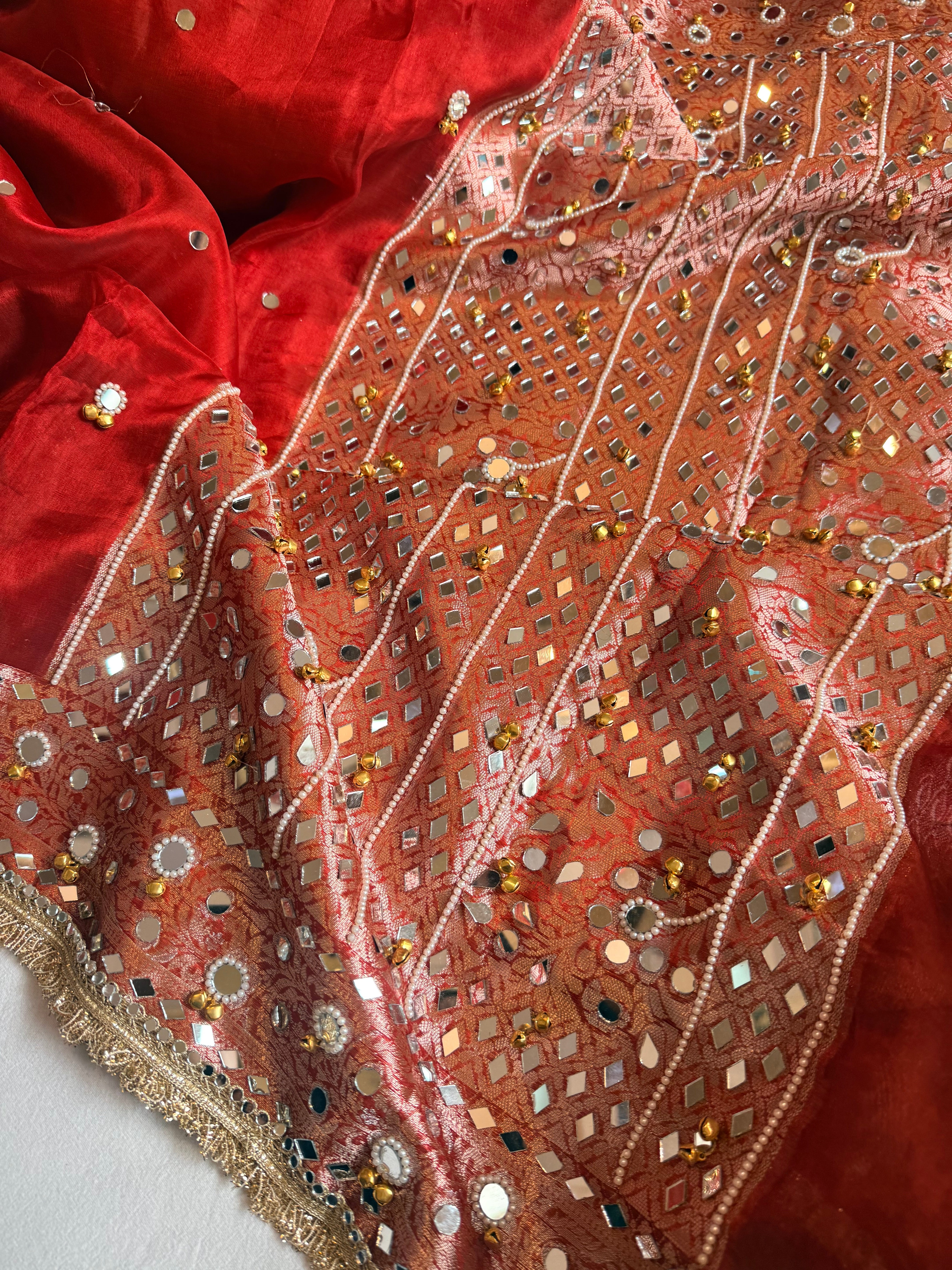 Sindoori red ghungroo and mirrorwork hand embroidered kadhwa saree