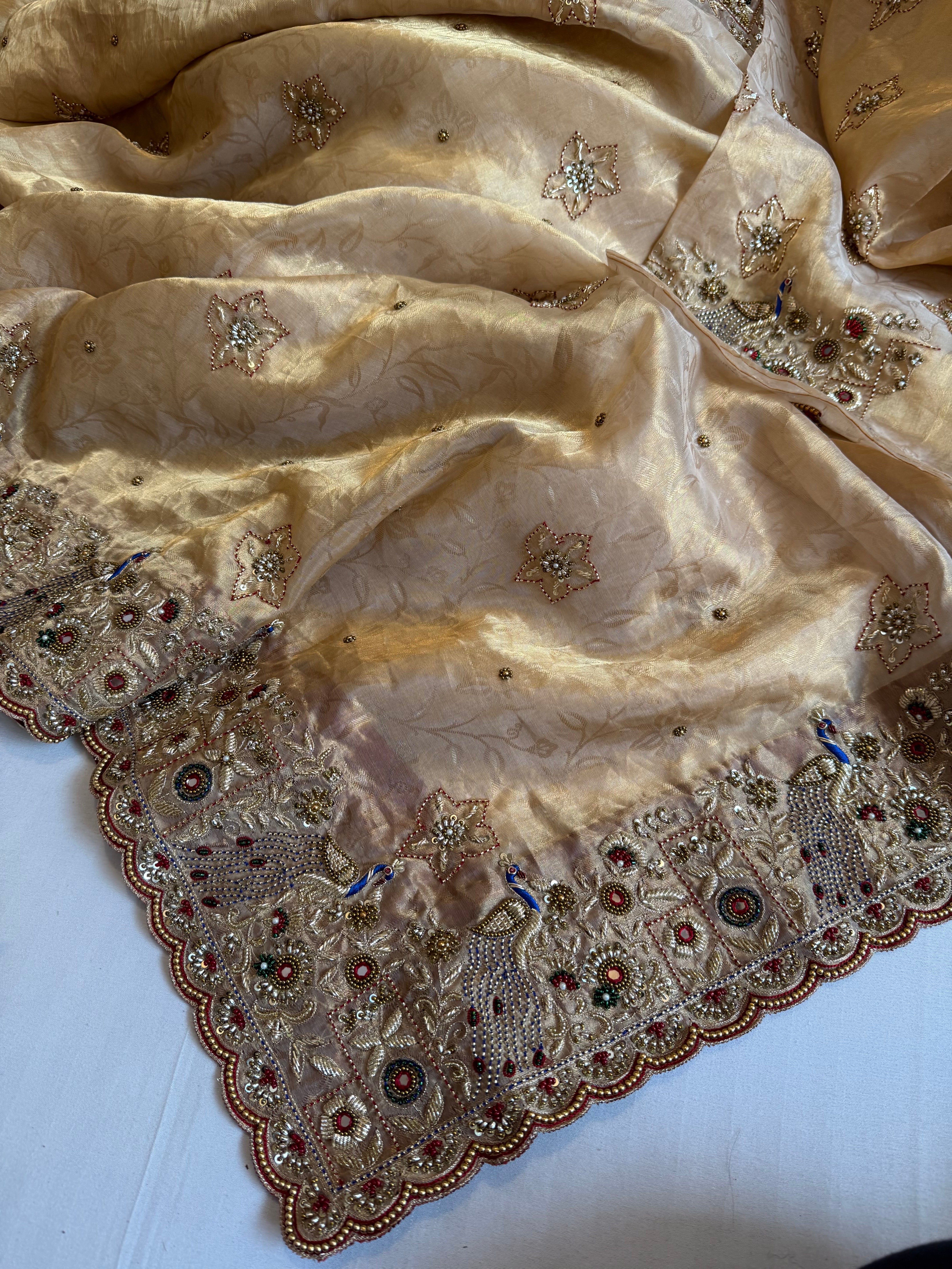 Jadau molten gold tissue silk hand embroidered peacock motif saree