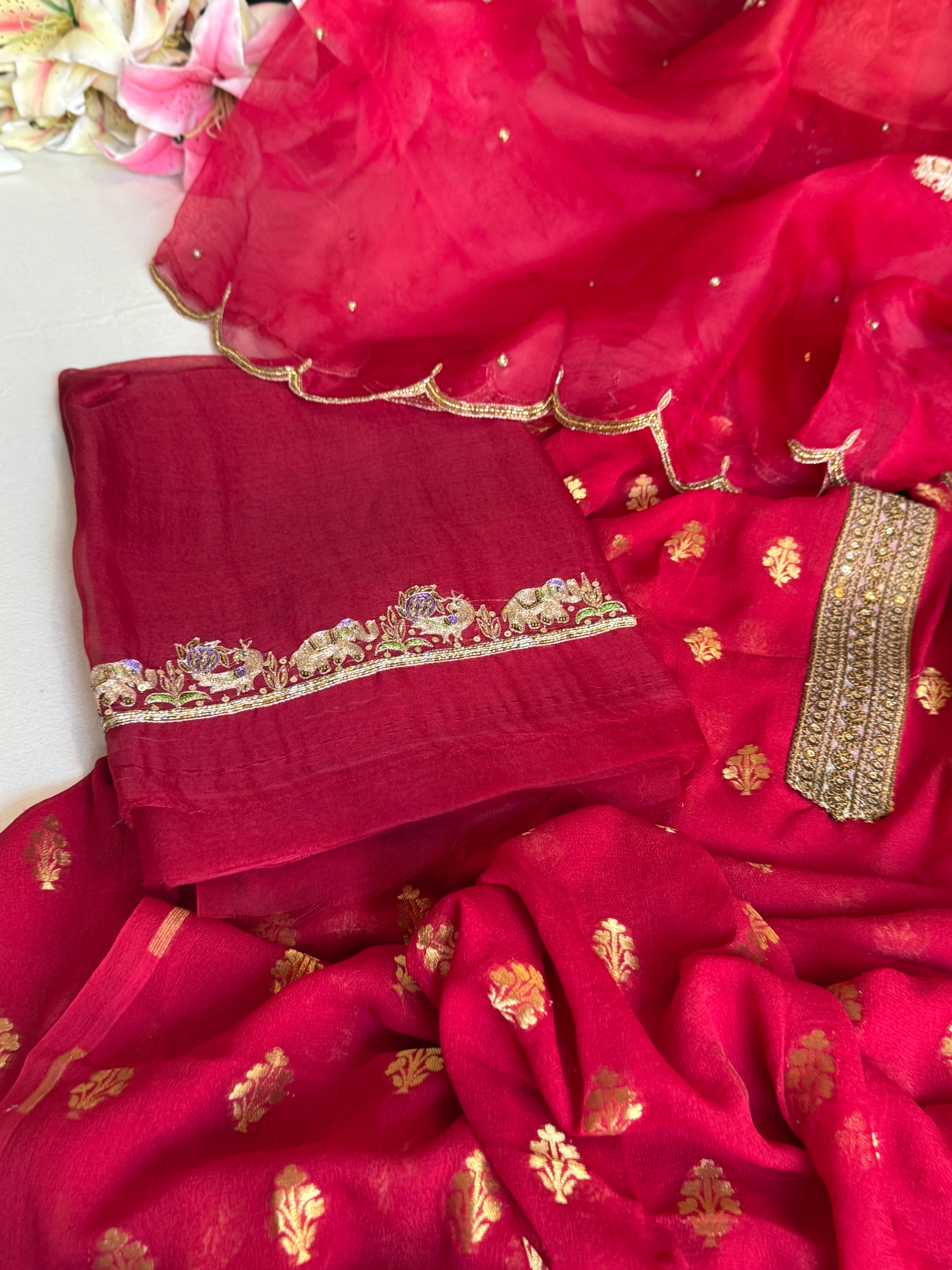 Crimson red banarasi gorgette kadhwa buti kurta paired with toy hathi motif kora silk scalloped duppata set