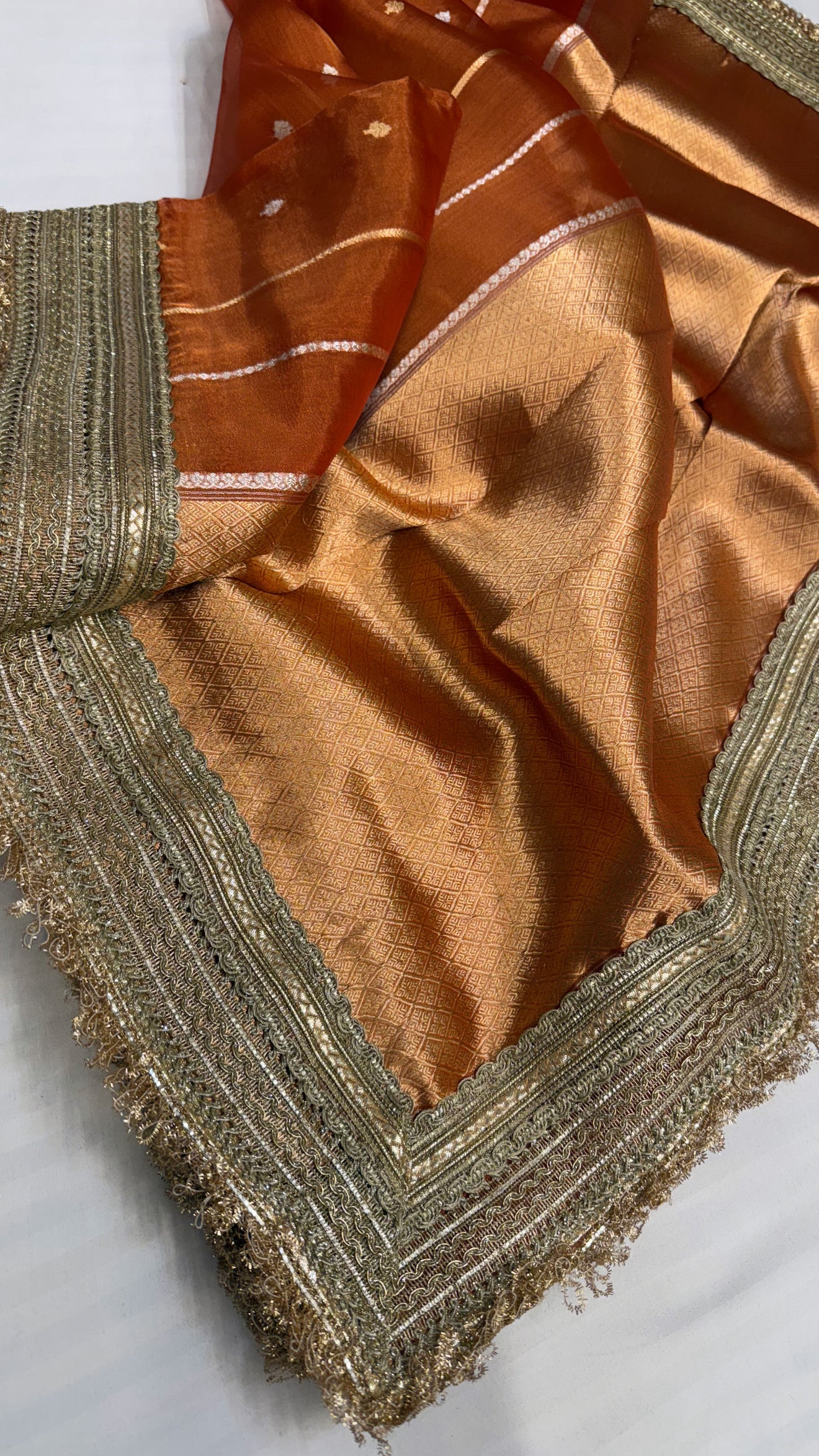 Maharani copperish orange tissue silk kadhwa buti saree